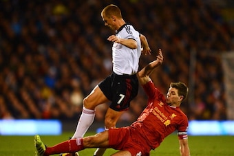 LONDON, ENGLAND - FEBRUARY 12: Steven Gerrard of Liverpool tackles Steve Sidwell of Fulham during the Barclays Premier League match between Fulham and Liverpool at Craven Cottage on February 12, 2014 in London, England.  (Photo by Mike Hewitt/Getty Images