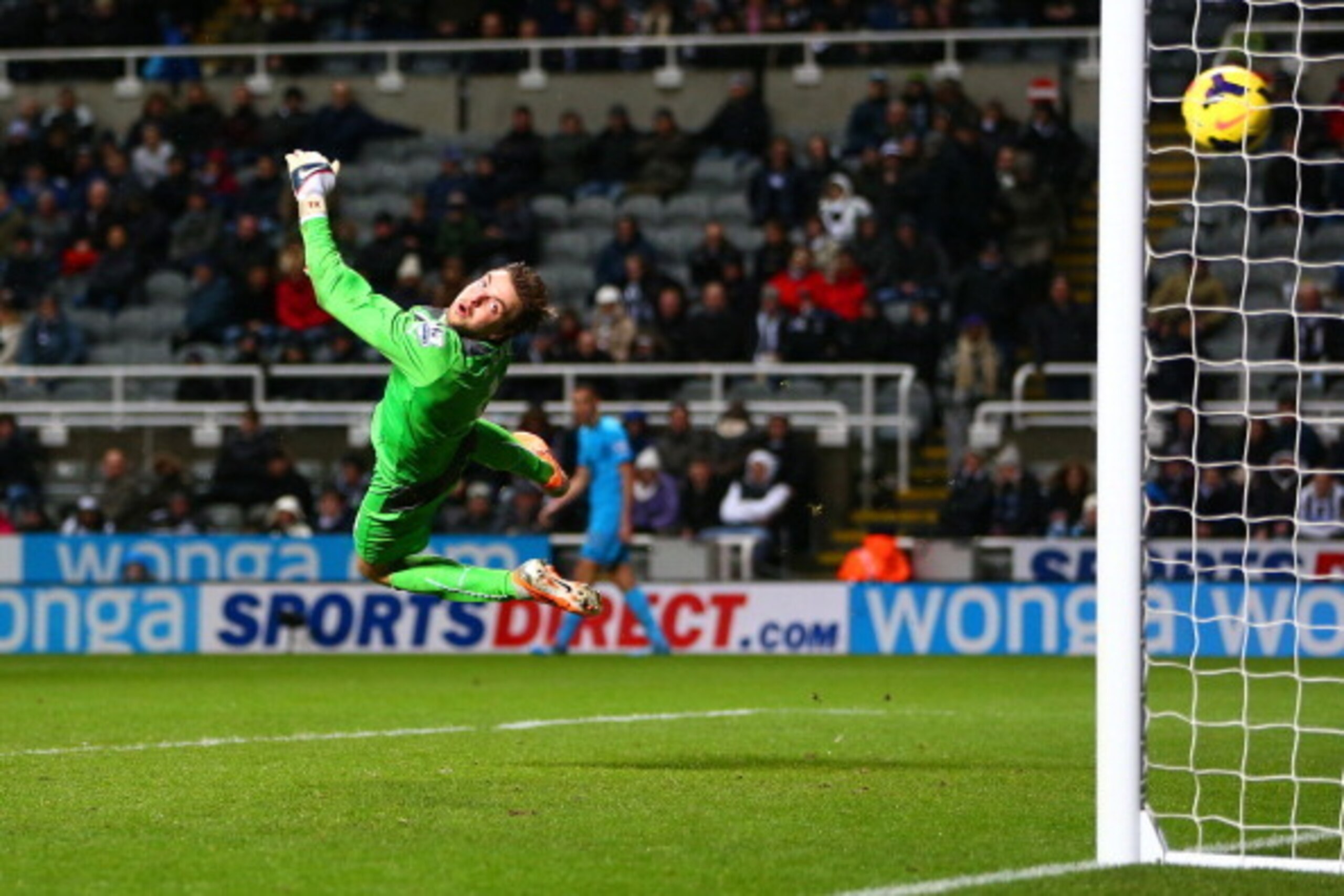 NEWCASTLE UPON TYNE, ENGLAND - FEBRUARY 12:  Tim Krul of Newcastle United dives but fails to save Nacer Chadli of Tottenham Hotspur's effort on goal during the Barclays Premier League match between  Newcastle United and Tottenham Hotspur at St James' Park