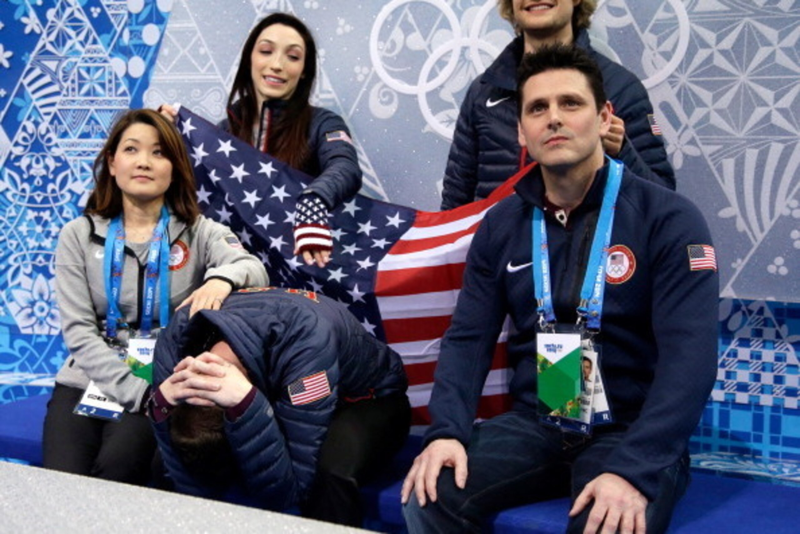 SOCHI, RUSSIA - FEBRUARY 06:  Jeremy Abbott of the United States reacts after seeing his scores as teammates Meryl Davis (back L) and Charlie White (back R) look on in the Figure Skating Men's Short Program during the Sochi 2014 Winter Olympics at Iceberg
