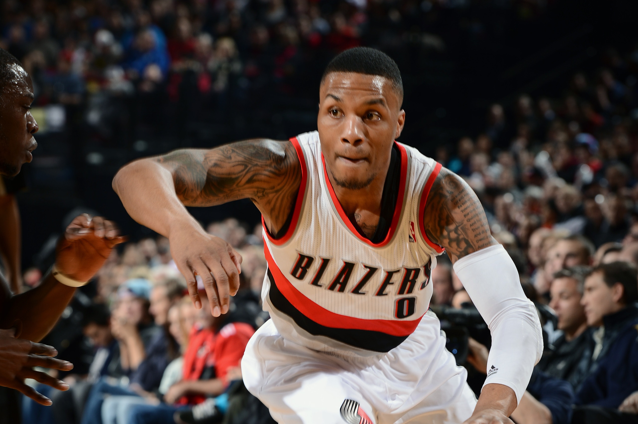 PORTLAND, OR - FEBRUARY 11: Damian Lillard #0 of The Portland Trail Blazers drives to the basket against the Oklahoma City Thunder on February 11, 2014 at the Moda Center in Portland, Oregon. NOTE TO USER: User expressly acknowledges and agrees that, by d