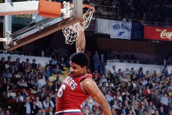 DENVER - 1984:  Julius Erving #6 of the Philadelphia 76ers follows through on his dunk during the Slam Dunk contest during All-Star Weekend circa 1984 at McNichols Arena in  Denver, Colorado.  NOTE TO USER: User expressly acknowledges  and agrees that, by