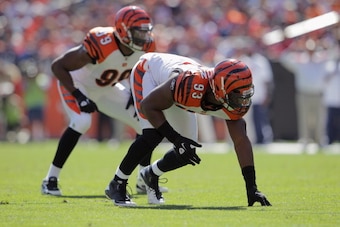 DENVER, CO - SEPTEMBER 18:  Defensive end Michael Johnson #93 of the Cincinnati Bengals and linebacker Manny Lawson #99 of the Cincinnati Bengals defend agains the Denver Broncos at Sports Authority Field at Mile High on September 18, 2011 in Denver, Colo