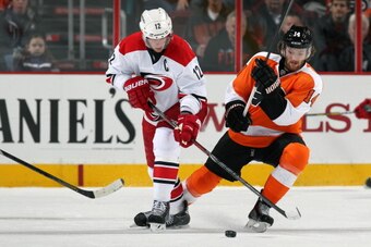 PHILADELPHIA, PA - JANUARY 22:  Sean Couturier #14 of the Philadelphia Flyers battles for the puck against Eric Staal #12 of the Carolina Hurricanes on January 22, 2014 at the Wells Fargo Center in Philadelphia, Pennsylvania.  (Photo by Len Redkoles/NHLI 
