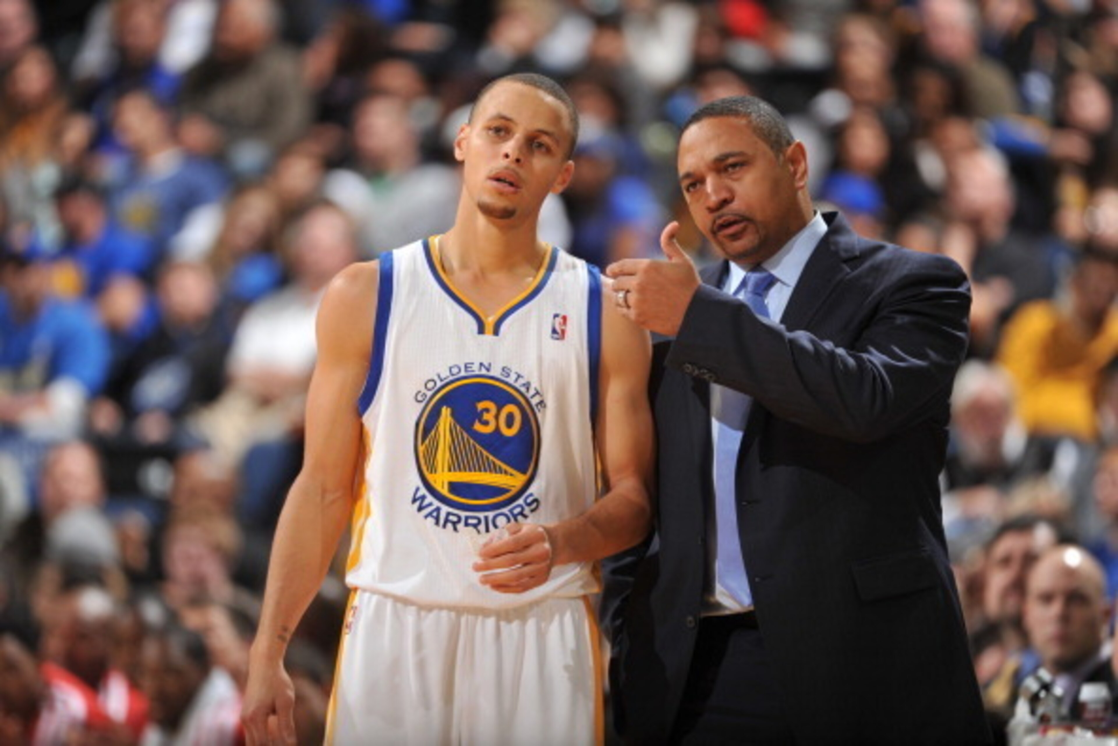 OAKLAND, CA - JANUARY 10: Head Coach Mark Jackson of the Golden State Warriors coaches player Stephen Curry #30 against the Boston Celtics on January 10, 2014 at Oracle Arena in Oakland, California. NOTE TO USER: User expressly acknowledges and agrees tha