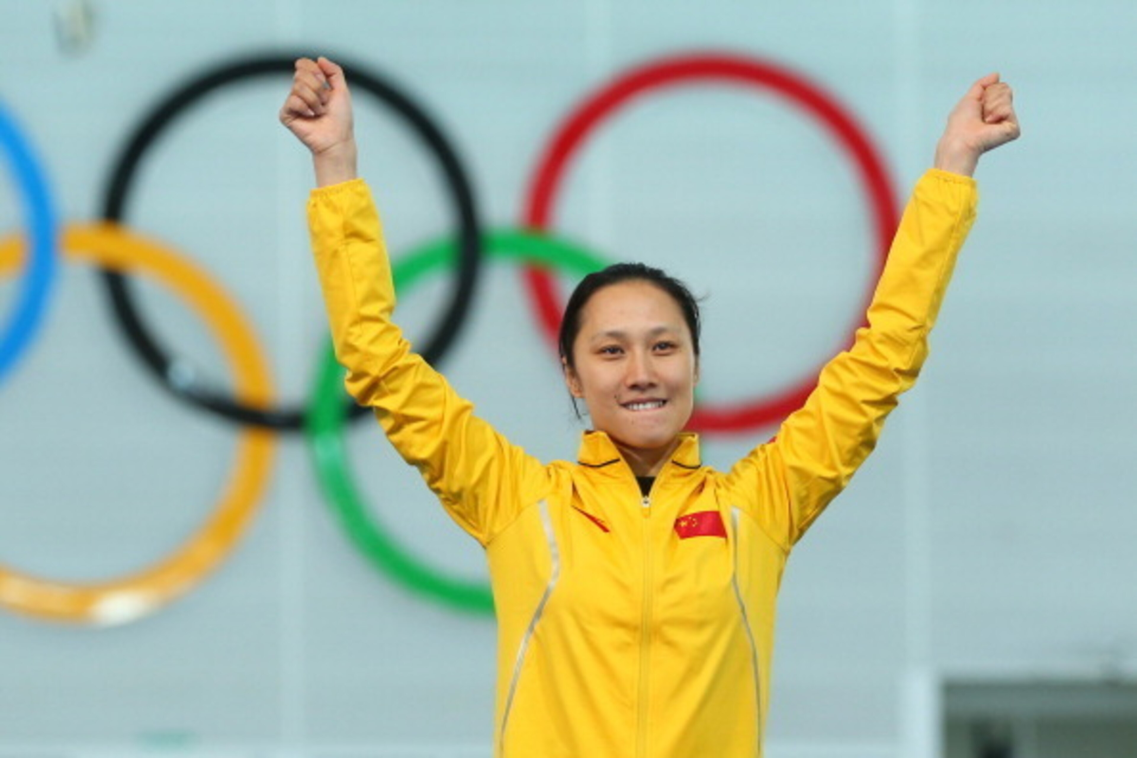 SOCHI, RUSSIA - FEBRUARY 13:  Gold medalist Hong Zhang of China celebrates on the podium during the flower ceremony for the Speed Skating Women's 1000m event on day 6 of the Sochi 2014 Winter Olympics at Adler Arena Skating Center on February 13, 2014 in 