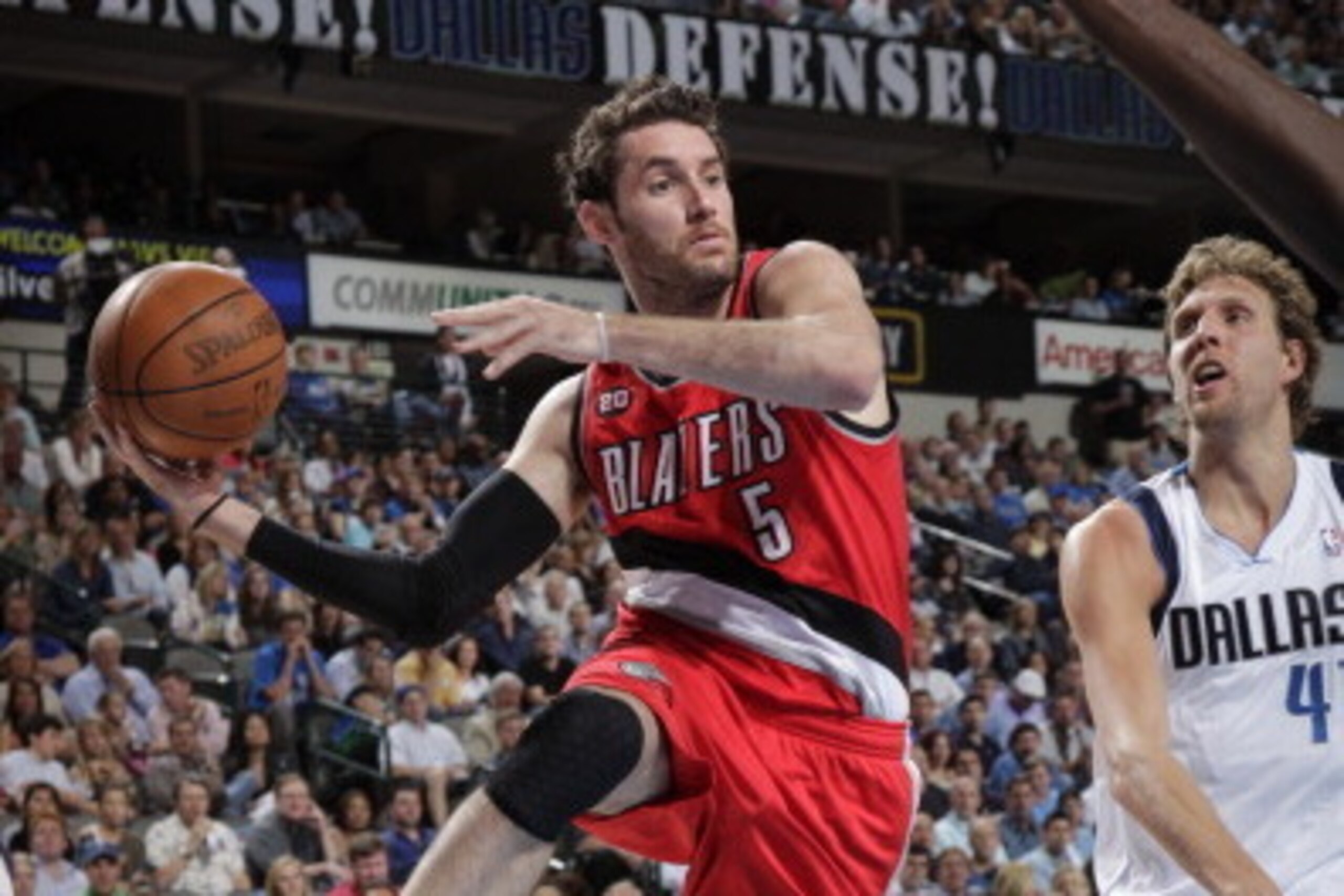 DALLAS, TX - APRIL 16: Rudy Fernandez #5 of the Portland Trail Blazers passes against Dirk Nowitzki #41 of the Dallas Mavericks during Game One of the Western Conference Quarterfinals in the 2011 NBA Playoffs on April 16, 2011 at the American Airlines Ce DALLAS, TX - APRIL 16: Rudy Fernandez #5 of the Portland Trail Blazers passes against Dirk Nowitzki #41 of the Dallas Mavericks during Game One of the Western Conference Quarterfinals in the 2011 NBA Playoffs on April 16, 2011 at the American Airlines Ce