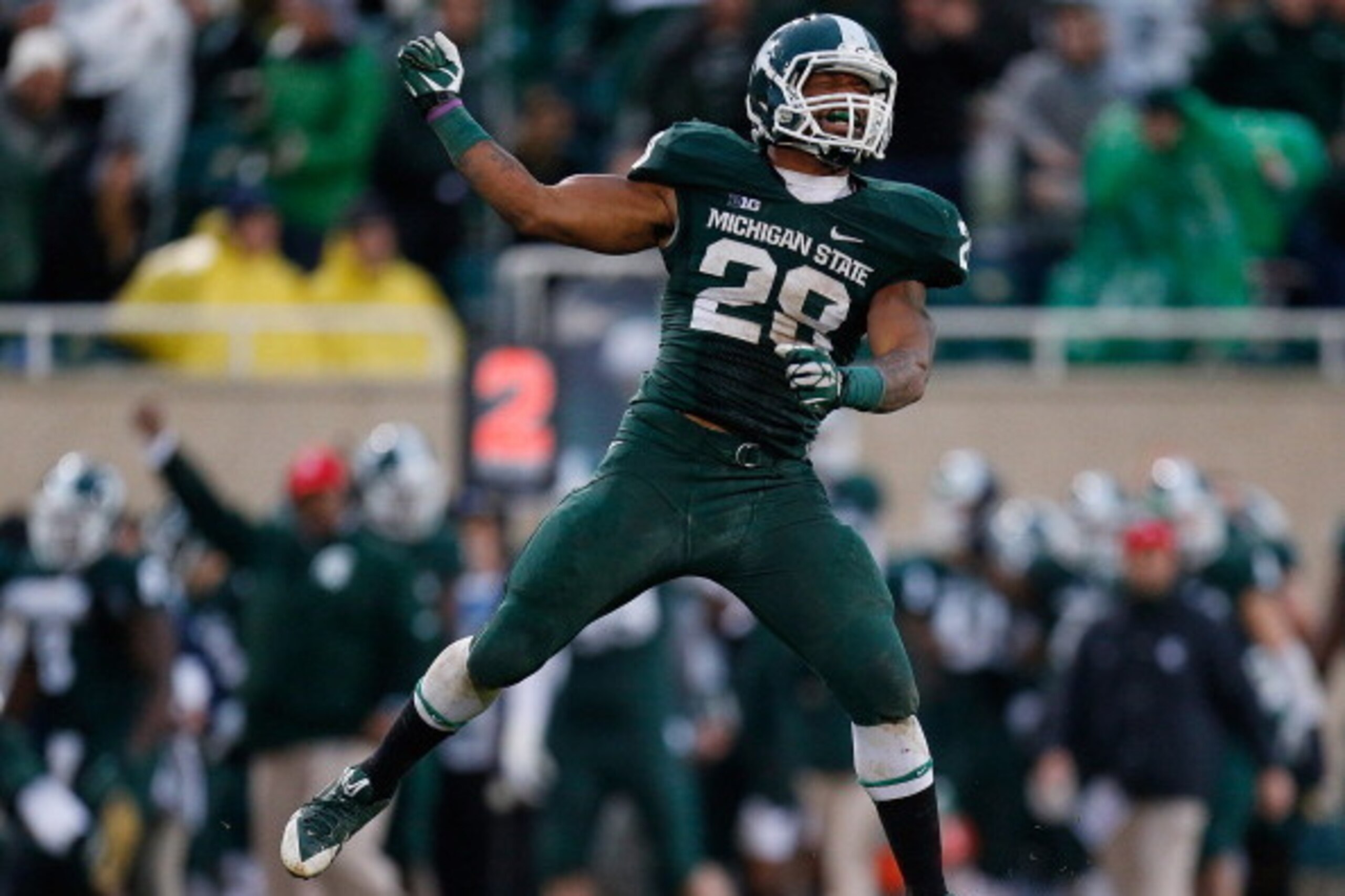 EAST LANSING, MI - NOVEMBER 02: Denicos Allen #28 of the Michigan State Spartans celebrates a third-quarter sack against the Michigan Wolverines at Spartan Stadium on November 2, 2013 in East Lansing, Michigan. Michigan State won the game 29-6. (Photo by 