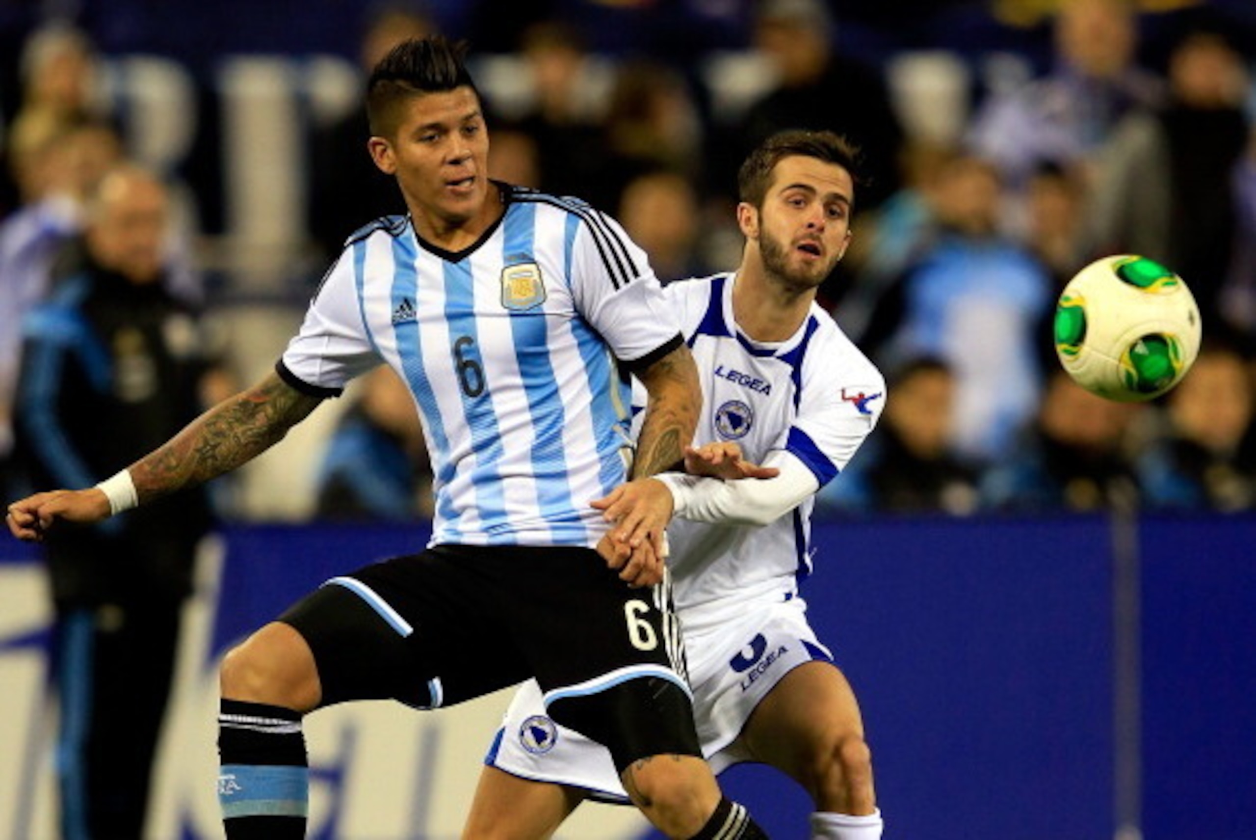 ST LOUIS, MO - NOVEMBER 18:  Marcos Rojo #6 of Argentina battles Miralem Pjanic #8 of Bosnia-Herzegovina during the international friendly match at Busch Stadium on November 18, 2013 in St Louis, Missouri.  (Photo by Jamie Squire/Getty Images)