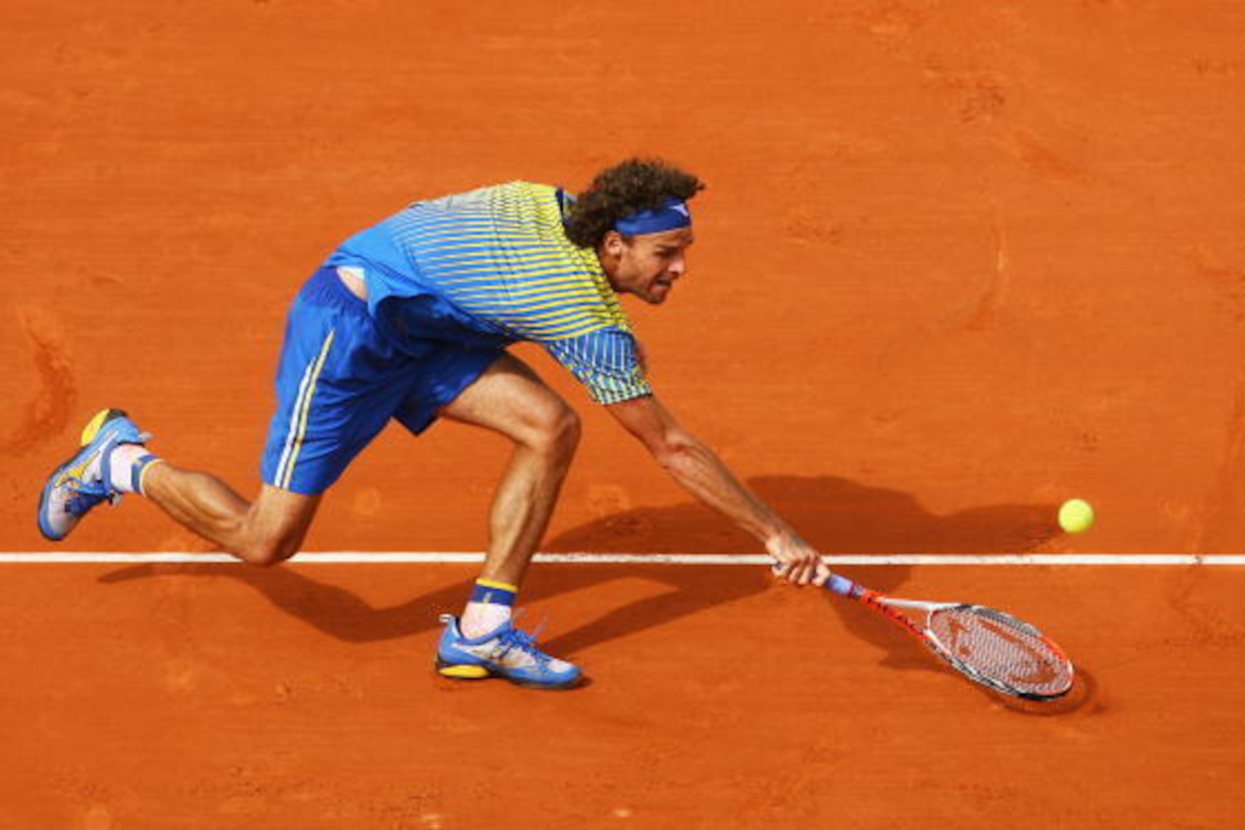PARIS - MAY 25:  Gustavo Kuerten of Brazil stretches for the ball during the Men's Singles first round match against Paul-Henri Mathieu of France on day one of the French Open at Roland Garros on May 25, 2008 in Paris, France. The French Open with be Kuer