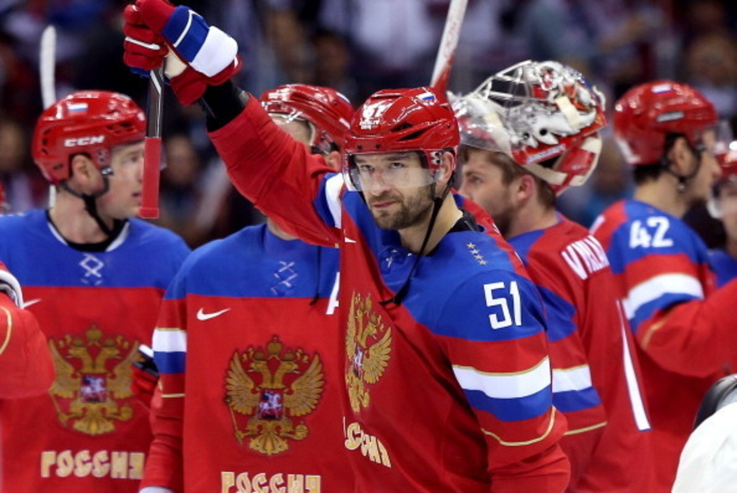 SOCHI, RUSSIA - FEBRUARY 13: Fyodor Tyutin #51 of Russia celebrates with teammates after defeating Slovenia 5-2 during the Men's Ice Hockey Preliminary Round Group A game on day six of the Sochi 2014 Winter Olympics at Bolshoy Ice Dome on February 13, 201
