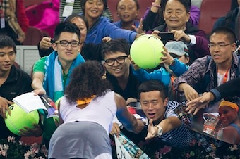 Serena Williams signs autographs for fans at 2013 China Open in Beijing.