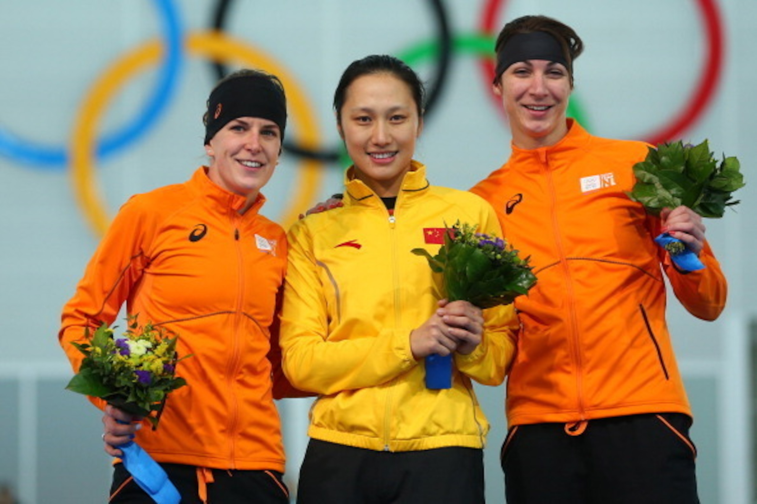 SOCHI, RUSSIA - FEBRUARY 13: (L-R) Silver medalist Ireen Wust of the Netherlands, gold medalist Hong Zhang of China and bronze medalist Margot Boer of the Netherlands celebrate on the podium during the flower ceremony for the Speed Skating Women's 1000m SOCHI, RUSSIA - FEBRUARY 13: (L-R) Silver medalist Ireen Wust of the Netherlands, gold medalist Hong Zhang of China and bronze medalist Margot Boer of the Netherlands celebrate on the podium during the flower ceremony for the Speed Skating Women's 1000m
