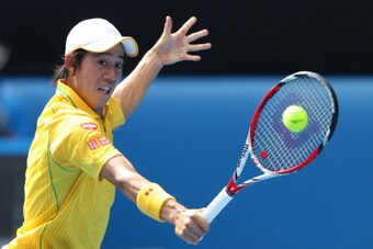 MELBOURNE, AUSTRALIA - JANUARY 20:  Kei Nishikori of Japan plays a backhand in his fourth round match against Rafael Nadal of Spain during day eight of the 2014 Australian Open at Melbourne Park on January 20, 2014 in Melbourne, Australia.  (Photo by Matt