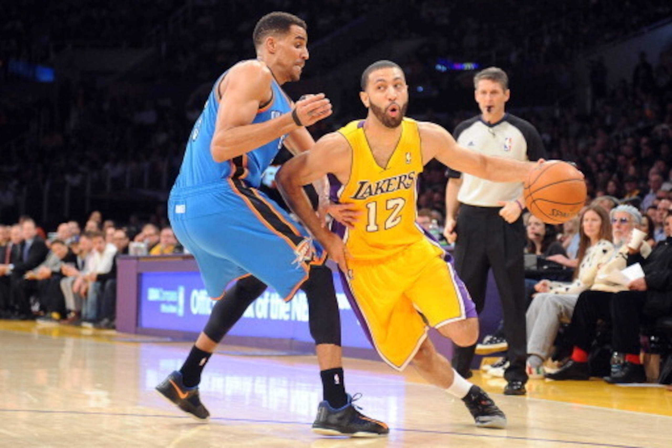 LOS ANGELES, CA - FEBRUARY 13: Kendall Marshall #12 of the Los Angeles Lakers dribbles against Thabo Sefolosha #25 of the Oklahoma City Thunder at Staples Center on February 13, 2014 in Los Angeles, California. NOTE TO USER: User expressly acknowledges an