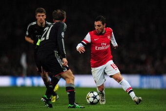 LONDON, ENGLAND - FEBRUARY 19:  Santi Cazorla of Arsenal in action against Philipp Lahm of Bayern Muenchen during the UEFA Champions League round of 16 first leg match between Arsenal and Bayern Muenchen at Emirates Stadium on February 19, 2013 in London,