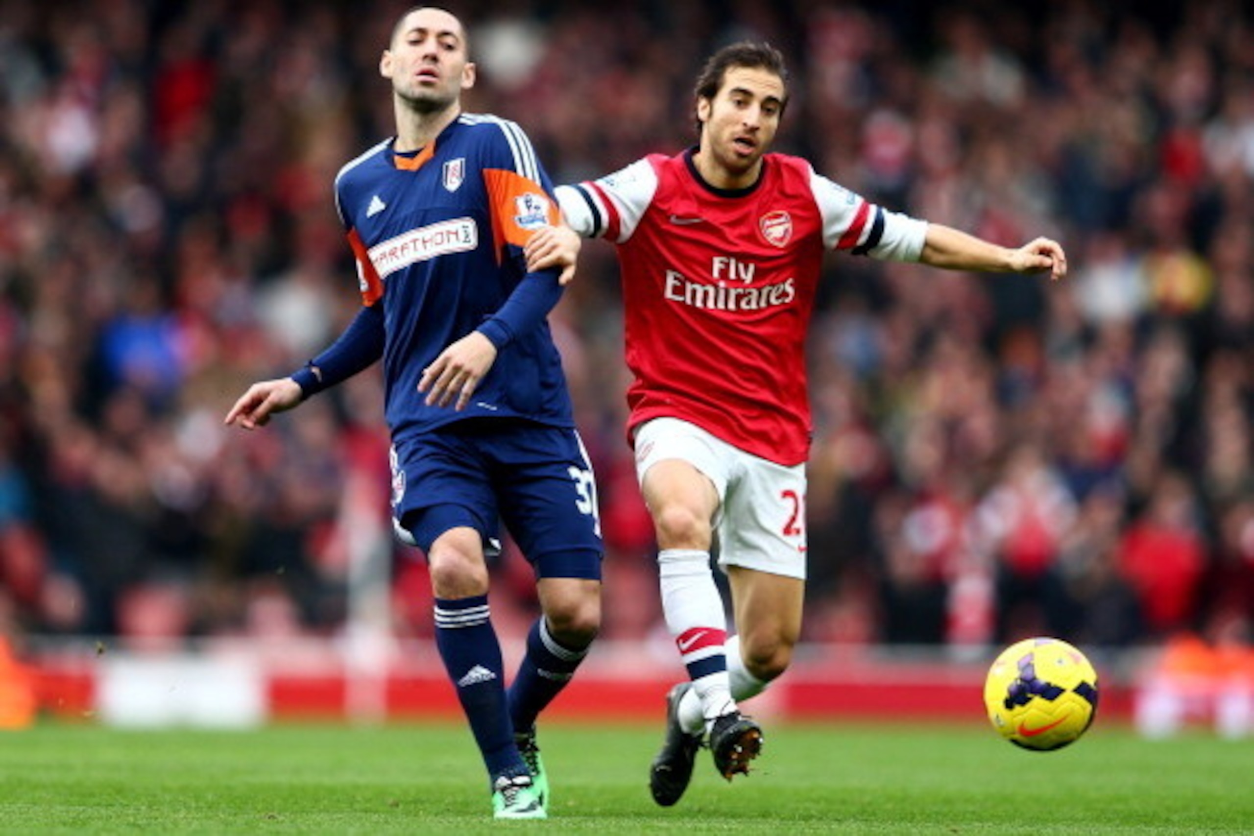 LONDON, ENGLAND - JANUARY 18:  Mathieu Flamini of Arsenal holds off Clint Dempsey of Fulham during the Barclays Premier League match between Arsenal and Fulham at Emirates Stadium on January 18, 2014 in London, England.  (Photo by Clive Mason/Getty Images