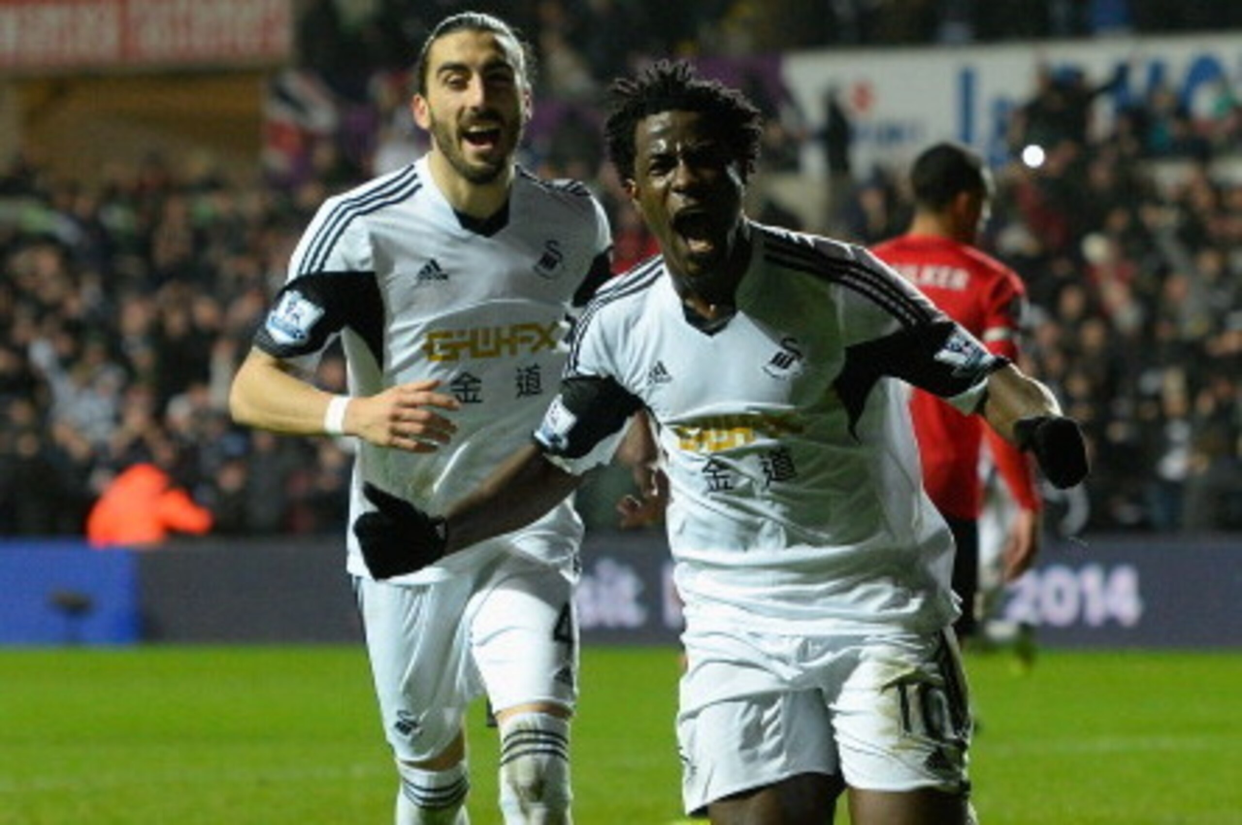 SWANSEA, WALES - FEBRUARY 08: Swansea striker Wilfried Bony (r) celebrates with Chico Flores after scoring the third goal during the Barclays Premier League match between Swansea City and Cardiff City at Liberty Stadium on February 8, 2014 in Swansea, Wa SWANSEA, WALES - FEBRUARY 08: Swansea striker Wilfried Bony (r) celebrates with Chico Flores after scoring the third goal during the Barclays Premier League match between Swansea City and Cardiff City at Liberty Stadium on February 8, 2014 in Swansea, Wa