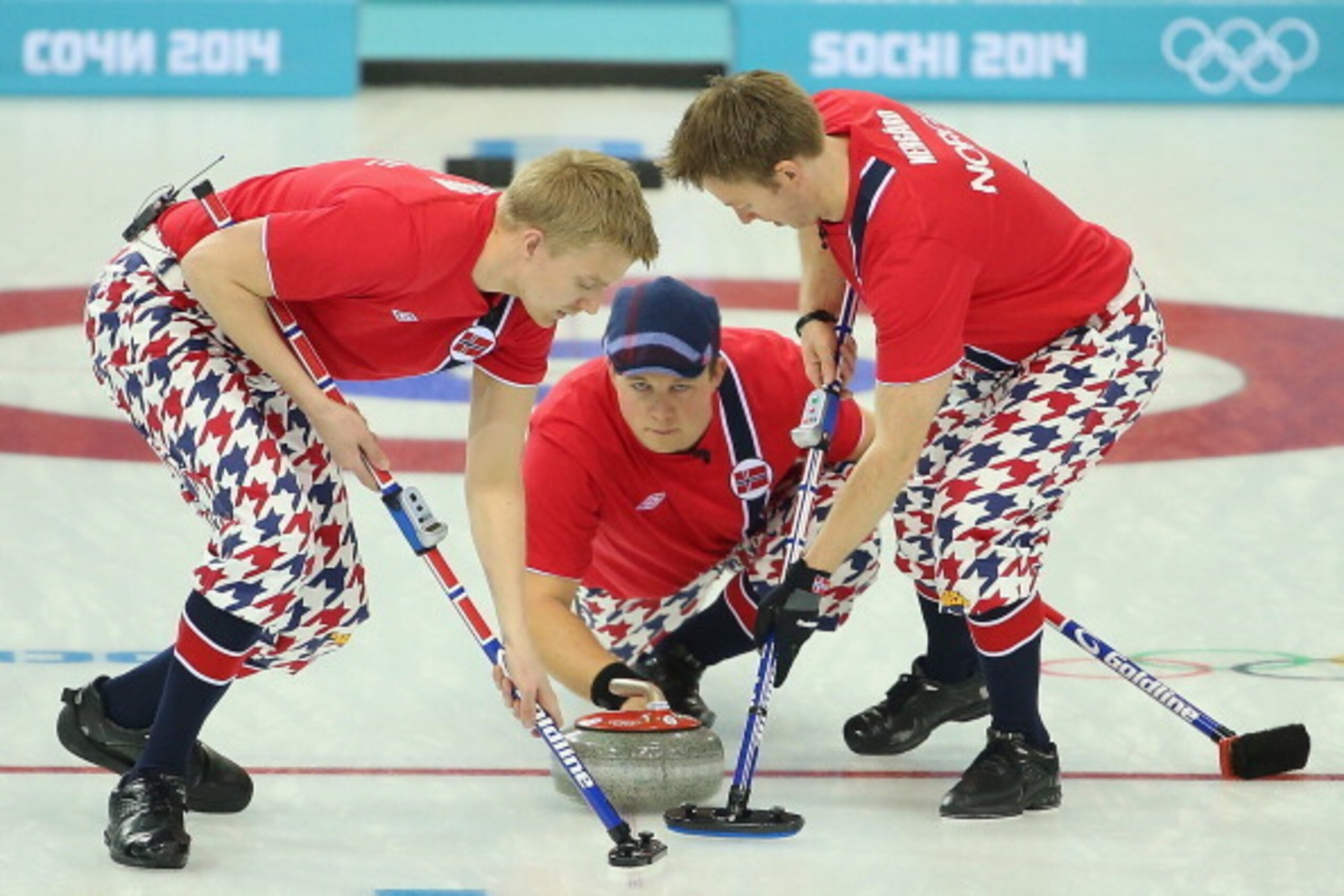 SOCHI, RUSSIA - FEBRUARY 12: Haavard Vad Petersson, Christoffer Svae and Torger Nergaard of Norway compete in the Curling Men's Round Robin match between Norway and Germany during day five of the Sochi 2014 Winter Olympics at Ice Cube Curling Center on Fe