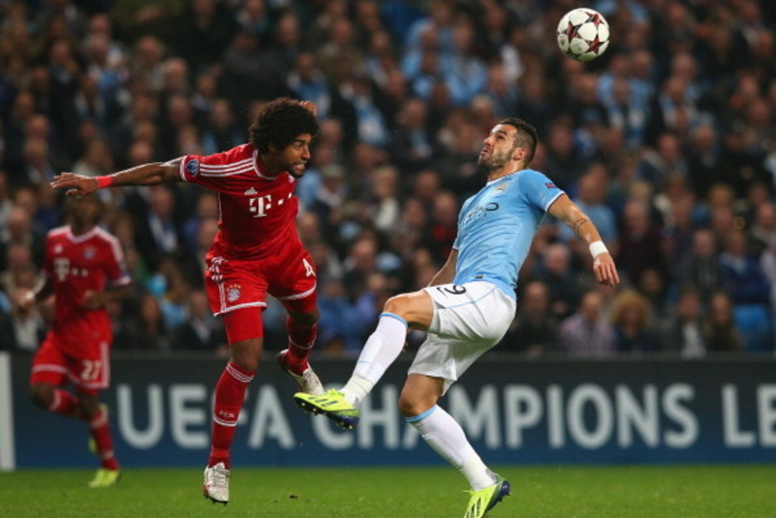 MANCHESTER, ENGLAND - OCTOBER 02:  Dante of Muenchen battle with Alvaro Negredo of Manchester City during the UEFA Champions League Group D match between Manchester City and FC Bayern Muenchen at Etihad Stadium on October 2, 2013 in Manchester, England.  