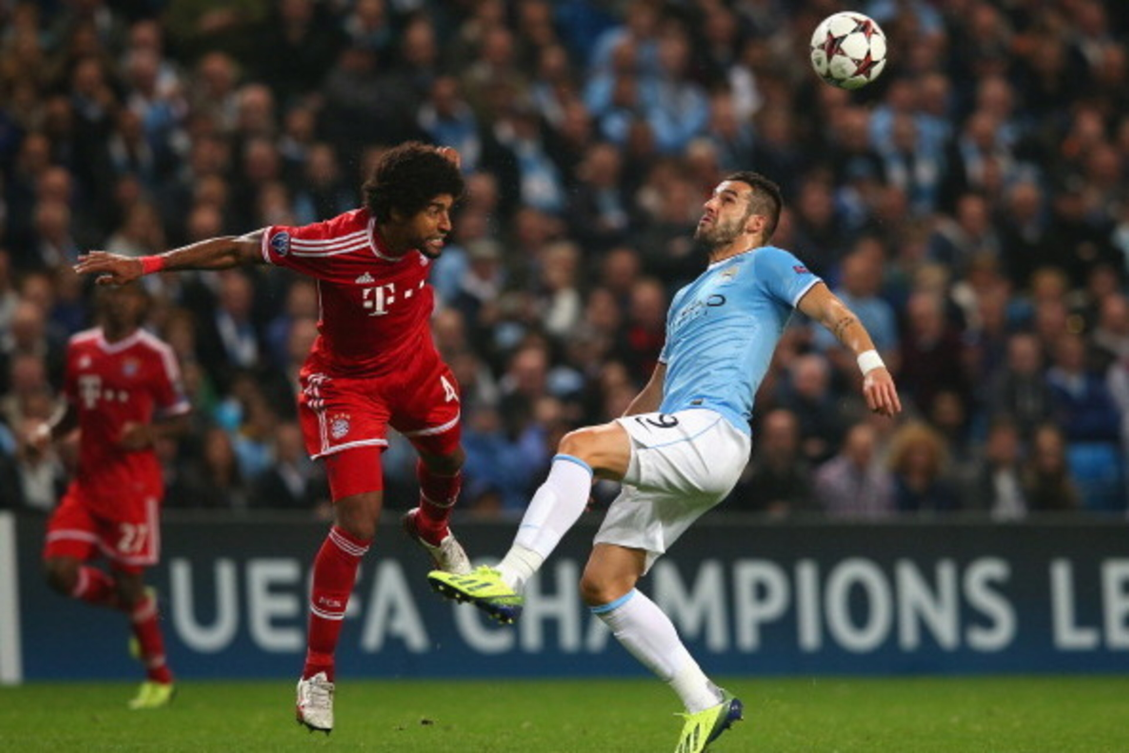 MANCHESTER, ENGLAND - OCTOBER 02:  Dante of Muenchen battle with Alvaro Negredo of Manchester City during the UEFA Champions League Group D match between Manchester City and FC Bayern Muenchen at Etihad Stadium on October 2, 2013 in Manchester, England.  