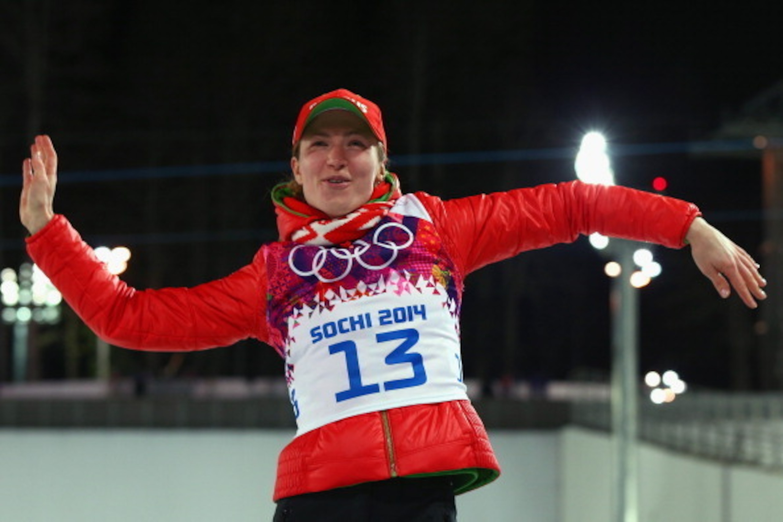 SOCHI, RUSSIA - FEBRUARY 14:  gold medalist Darya Domracheva of Belarus celebrates on the podium during the flower ceremony for the Women's 15 km Individual during day seven of the Sochi 2014 Winter Olympics at Laura Cross-country Ski & Biathlon Center on