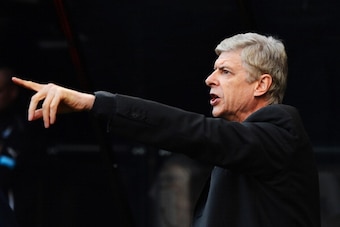 NEWCASTLE UPON TYNE, ENGLAND - DECEMBER 29: Arsene Wenger, manager of Arsenal makes his point during the Barclays Premier League match between Newcastle United and Arsenal at St James' Park on December 29, 2013 in Newcastle upon Tyne, England.  (Photo by 