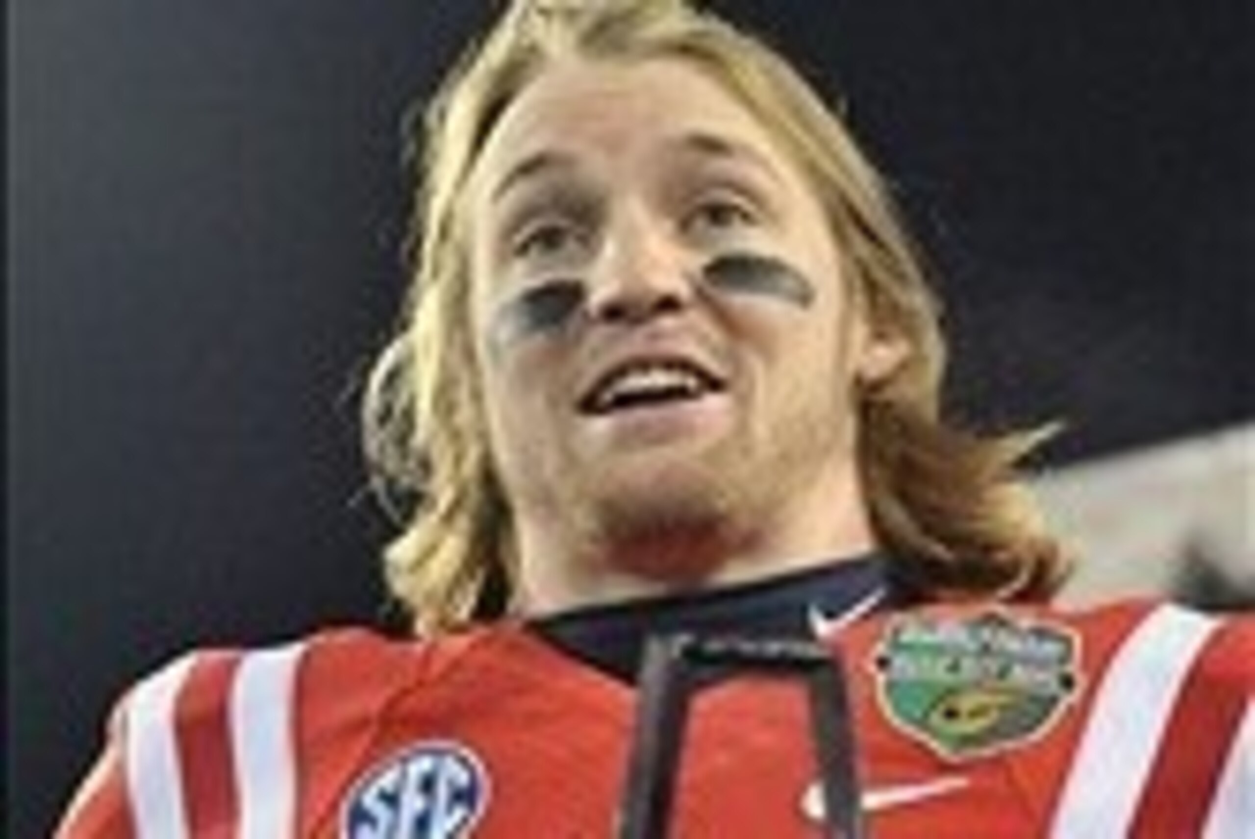 Dec 30, 2013; Nashville, TN, USA; Mississippi Rebels quarterback Bo Wallace (14) accepts the MVP trophy after defeated the Georgia Tech Yellow Jackets 25-17 at LP Field. Mandatory Credit: Jim Brown-USA TODAY Sports