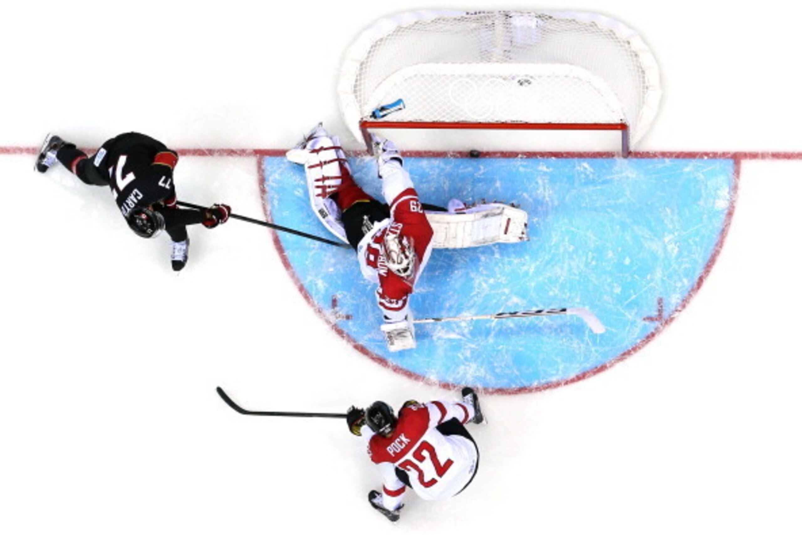 SOCHI, RUSSIA - FEBRUARY 14:  Jeff Carter #77 of Canada scores a goal in the second period against Bernhard Starkbaum #29 of Austria during the Men's Ice Hockey Preliminary Round Group B game on day seven of the Sochi 2014 Winter Olympics at Bolshoy Ice D