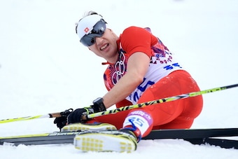 SOCHI, RUSSIA - FEBRUARY 14:  Dario Cologna of Switzerland collapses in the snow after competing in the Men's 15 km Classic during day seven of the Sochi 2014 Winter Olympics at Laura Cross-country Ski & Biathlon Center on February 14, 2014 in Sochi, Russ