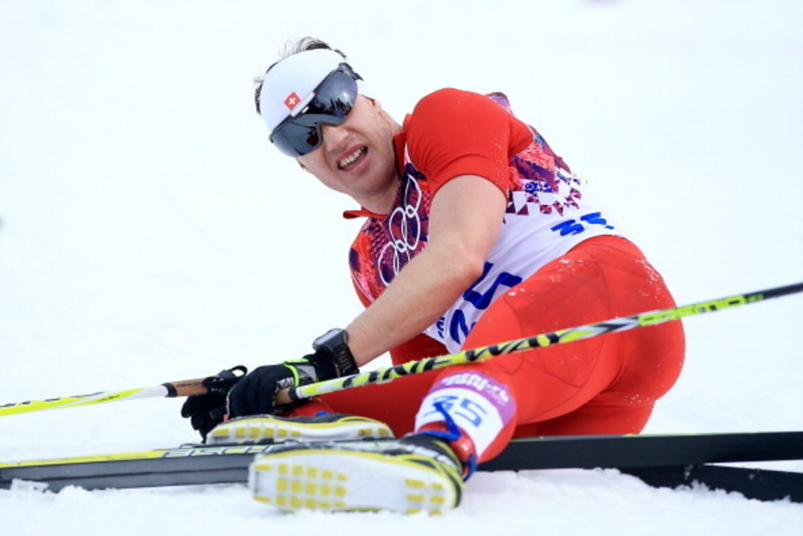 SOCHI, RUSSIA - FEBRUARY 14:  Dario Cologna of Switzerland collapses in the snow after competing in the Men's 15 km Classic during day seven of the Sochi 2014 Winter Olympics at Laura Cross-country Ski & Biathlon Center on February 14, 2014 in Sochi, Russ