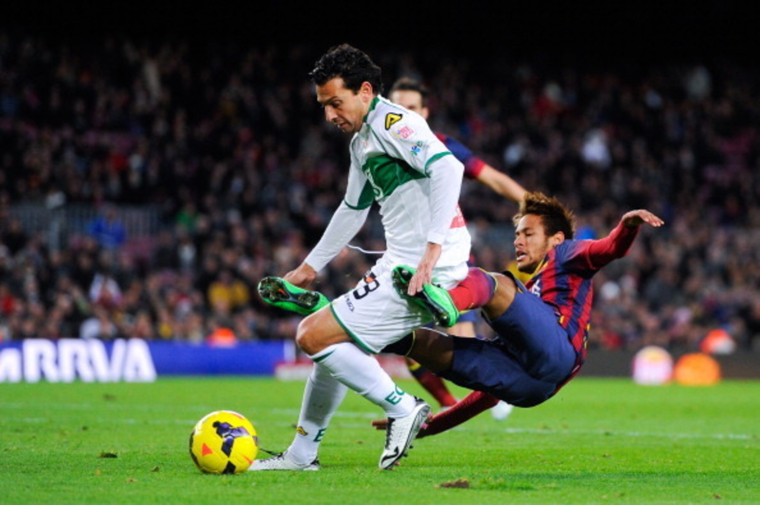 BARCELONA, SPAIN - JANUARY 05:  Neymar of FC Barcelona is brought down by Sergio Mantecon of Elche FC during the La Liga match between FC Barcelona and Elche FC at Camp Nou on January 5, 2014 in Barcelona, Spain.  (Photo by David Ramos/Getty Images)