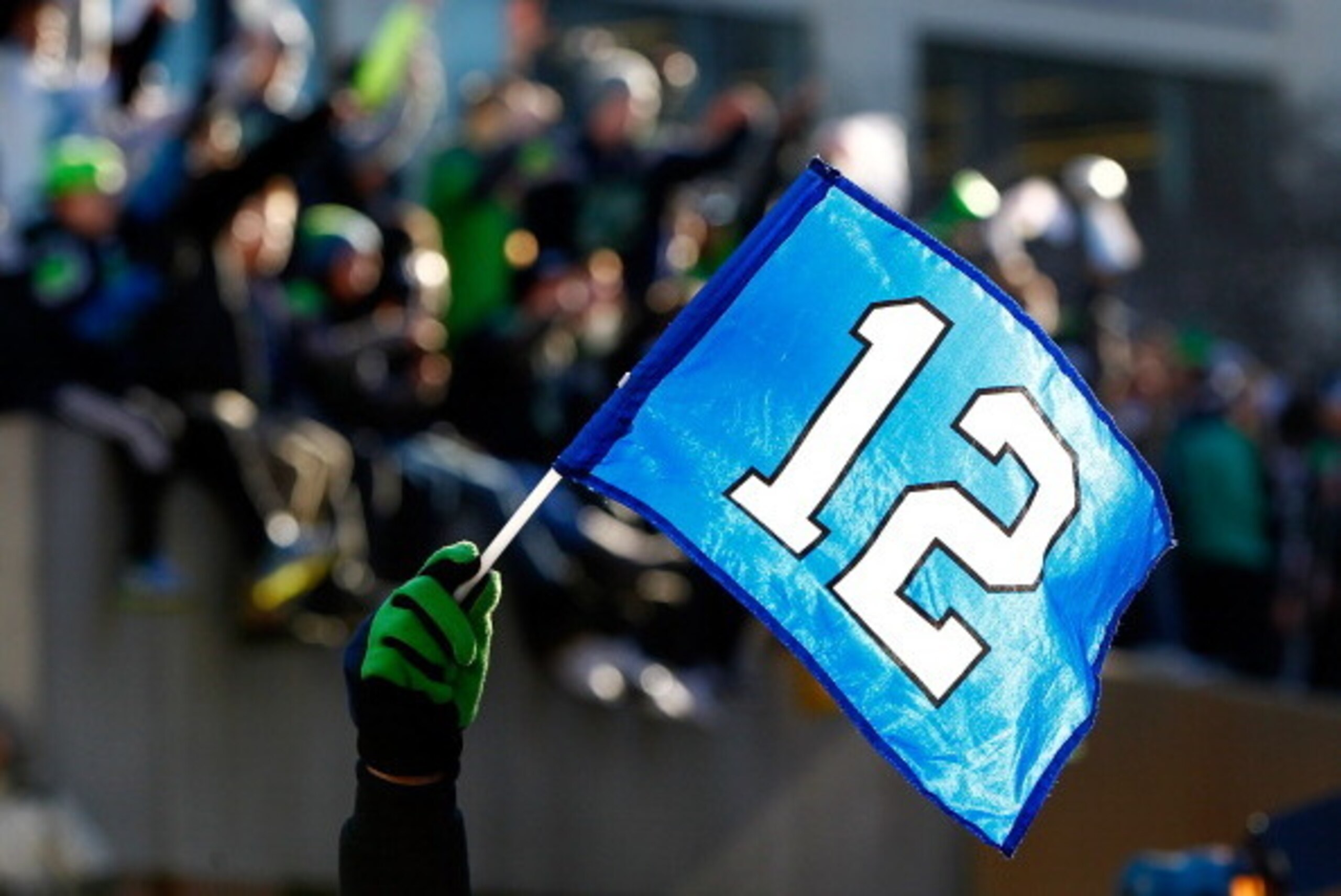 SEATTLE - FEBRUARY 05:  Fans wave the 12th Man flag to celebrate Seattle Seahawks victory in Super Bowl XLVII during a parade on February 5, 2014 in Seattle, Washington.  (Photo by Jonathan Ferrey/Getty Images)
