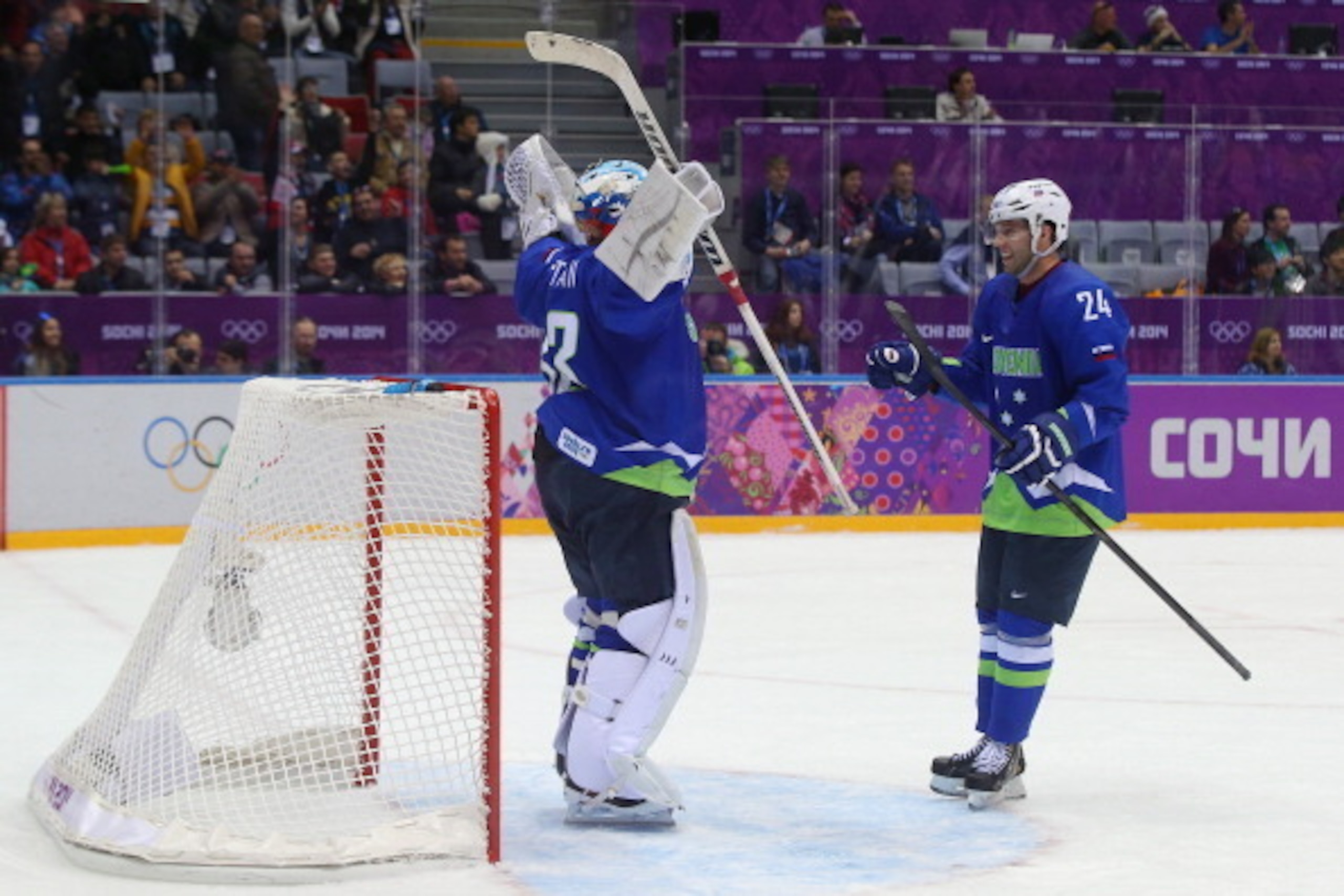 SOCHI, RUSSIA - FEBRUARY 15:  Robert Kristan #33 of Slovenia celebrates with Rok Ticar #24 after defeating Slovakia 3-1 during the Men's Ice Hockey Preliminary Round Group A game on day eight of the Sochi 2014 Winter Olympics at Bolshoy Ice Dome on Februa