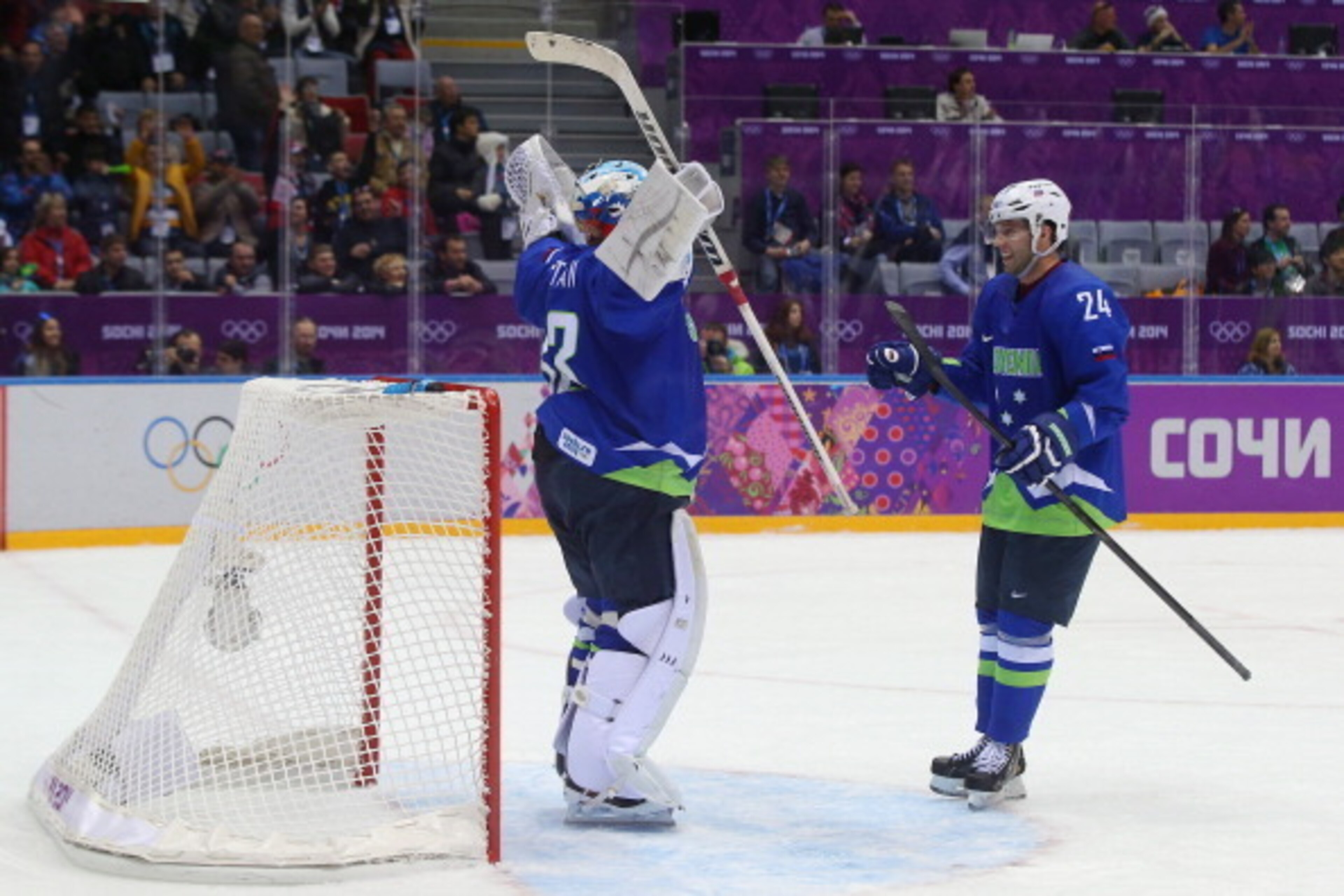 SOCHI, RUSSIA - FEBRUARY 15:  Robert Kristan #33 of Slovenia celebrates with Rok Ticar #24 after defeating Slovakia 3-1 during the Men's Ice Hockey Preliminary Round Group A game on day eight of the Sochi 2014 Winter Olympics at Bolshoy Ice Dome on Februa