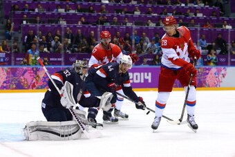 SOCHI, RUSSIA - FEBRUARY 15:  Alexander Syomin #28 of Russia shoots the puck against Jonathan Quick #32 of United States during the Men's Ice Hockey Preliminary Round Group A game on day eight of the Sochi 2014 Winter Olympics at Bolshoy Ice Dome on Febru