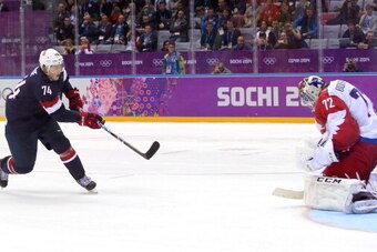 SOCHI, RUSSIA - FEBRUARY 15:  T.J. Oshie #74 of the United States scores on a shootout against Sergei Bobrovski #72 of Russia to win the Men's Ice Hockey Preliminary Round Group A game on day eight of the Sochi 2014 Winter Olympics at Bolshoy Ice Dome on