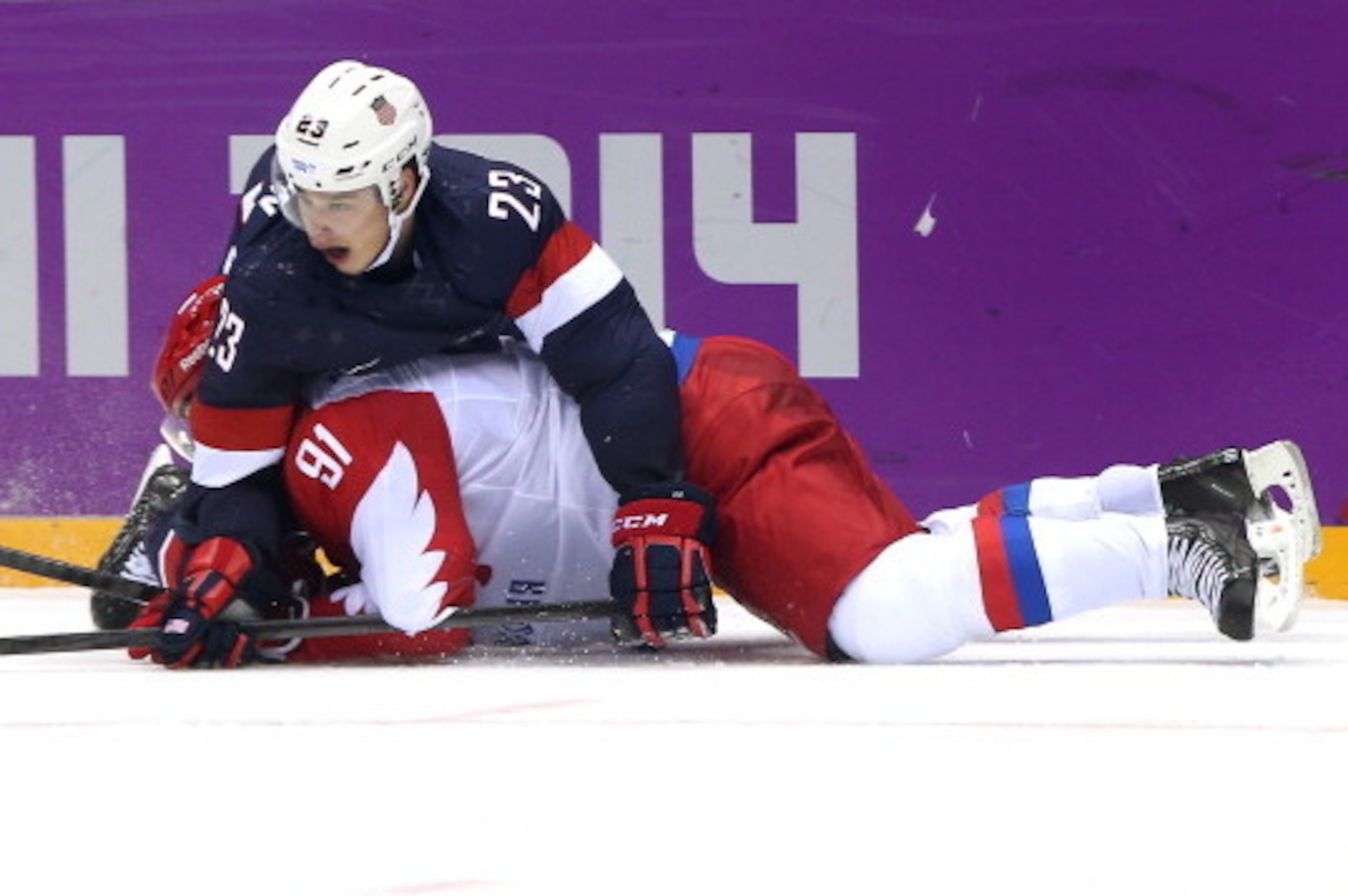 SOCHI, RUSSIA - FEBRUARY 15: Vladimir Tarasenko #91 of Russia and Dustin Brown #23 of the United States fall to the ice during the Men's Ice Hockey Preliminary Round Group A game on day eight of the Sochi 2014 Winter Olympics at Bolshoy Ice Dome on Febru SOCHI, RUSSIA - FEBRUARY 15: Vladimir Tarasenko #91 of Russia and Dustin Brown #23 of the United States fall to the ice during the Men's Ice Hockey Preliminary Round Group A game on day eight of the Sochi 2014 Winter Olympics at Bolshoy Ice Dome on Febru