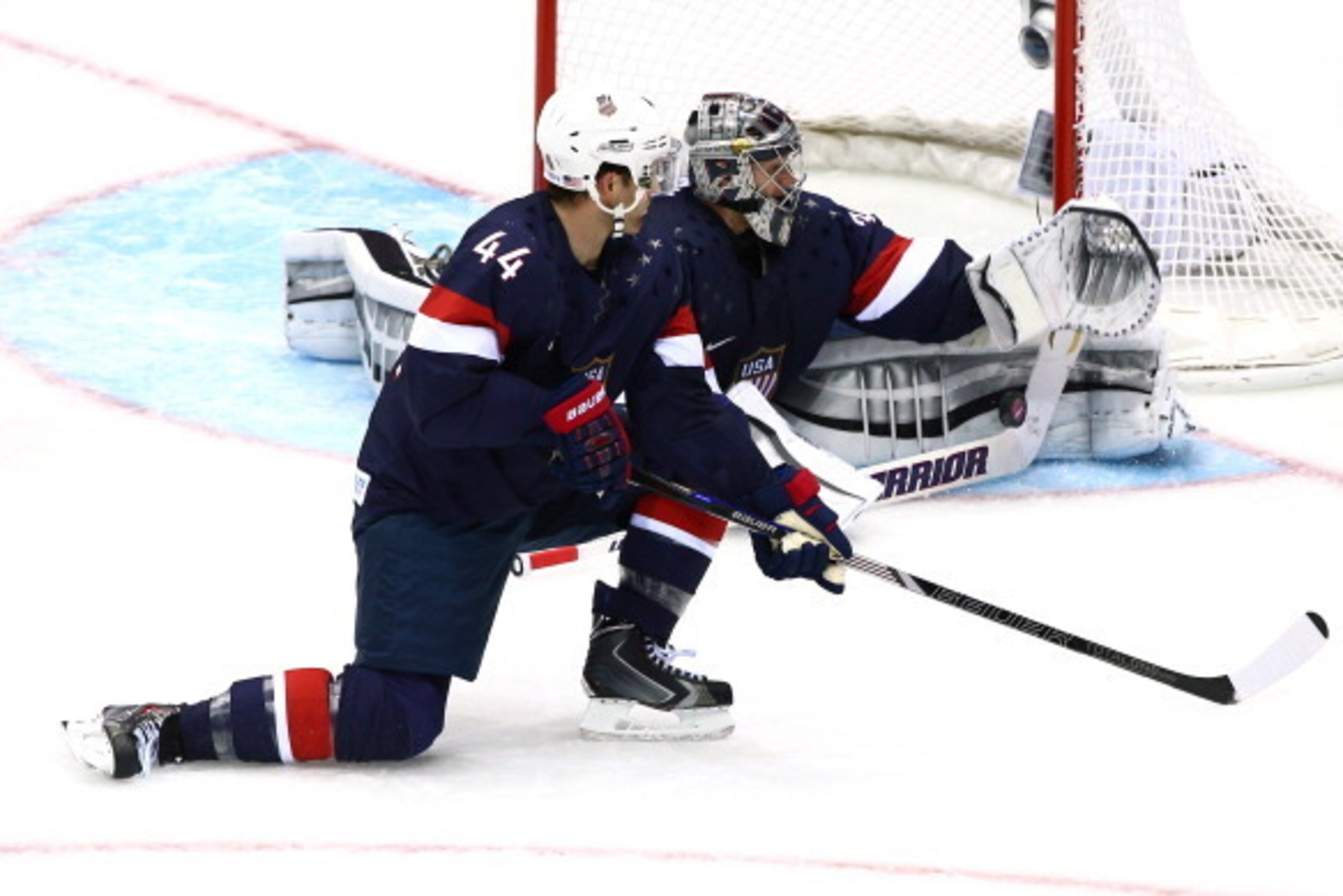SOCHI, RUSSIA - FEBRUARY 15:  Jonathan Quick #32 of the United States makes a save against Russia as teammate Brooks Orpik #44 looks on during the Men's Ice Hockey Preliminary Round Group A game on day eight of the Sochi 2014 Winter Olympics at Bolshoy Ic