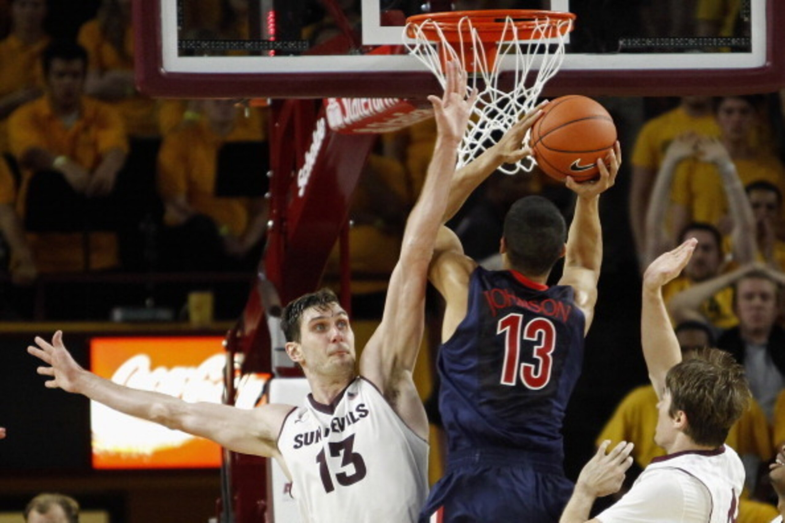 TEMPE, AZ - FEBRUARY 14:  Jordon Bachynski #13 of the Arizona State Sun Devils looks to block the shot of Nick Johnson #13 of the Arizona Wildcats during the overtime period of a college basketball game at Wells Fargo Arena on February 14, 2014 in Tempe, 