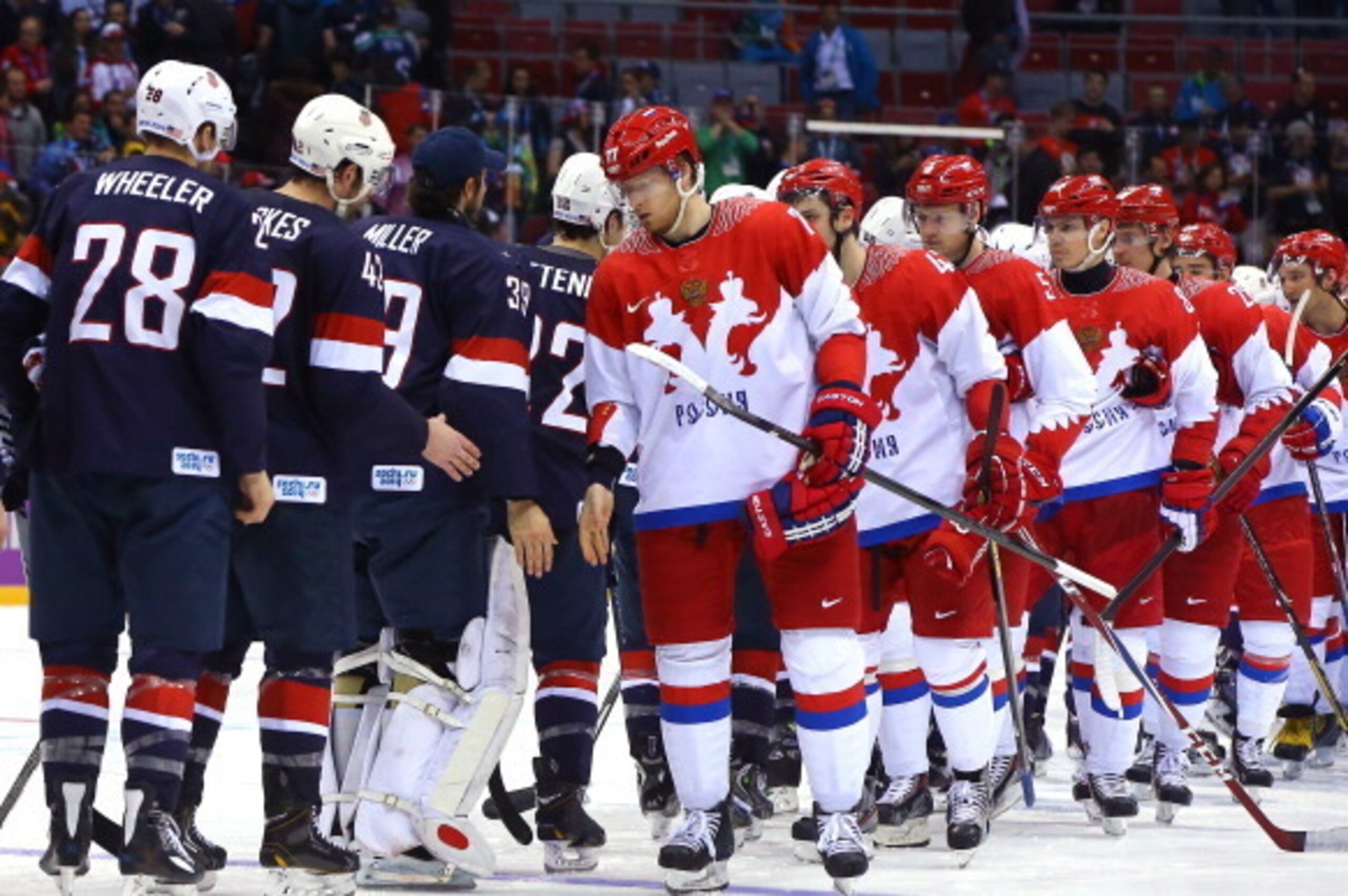 SOCHI, RUSSIA - FEBRUARY 15:  Russian and American players shake hands after the United States won 3-2 against Russia during the Men's Ice Hockey Preliminary Round Group A game on day eight of the Sochi 2014 Winter Olympics at Bolshoy Ice Dome on February