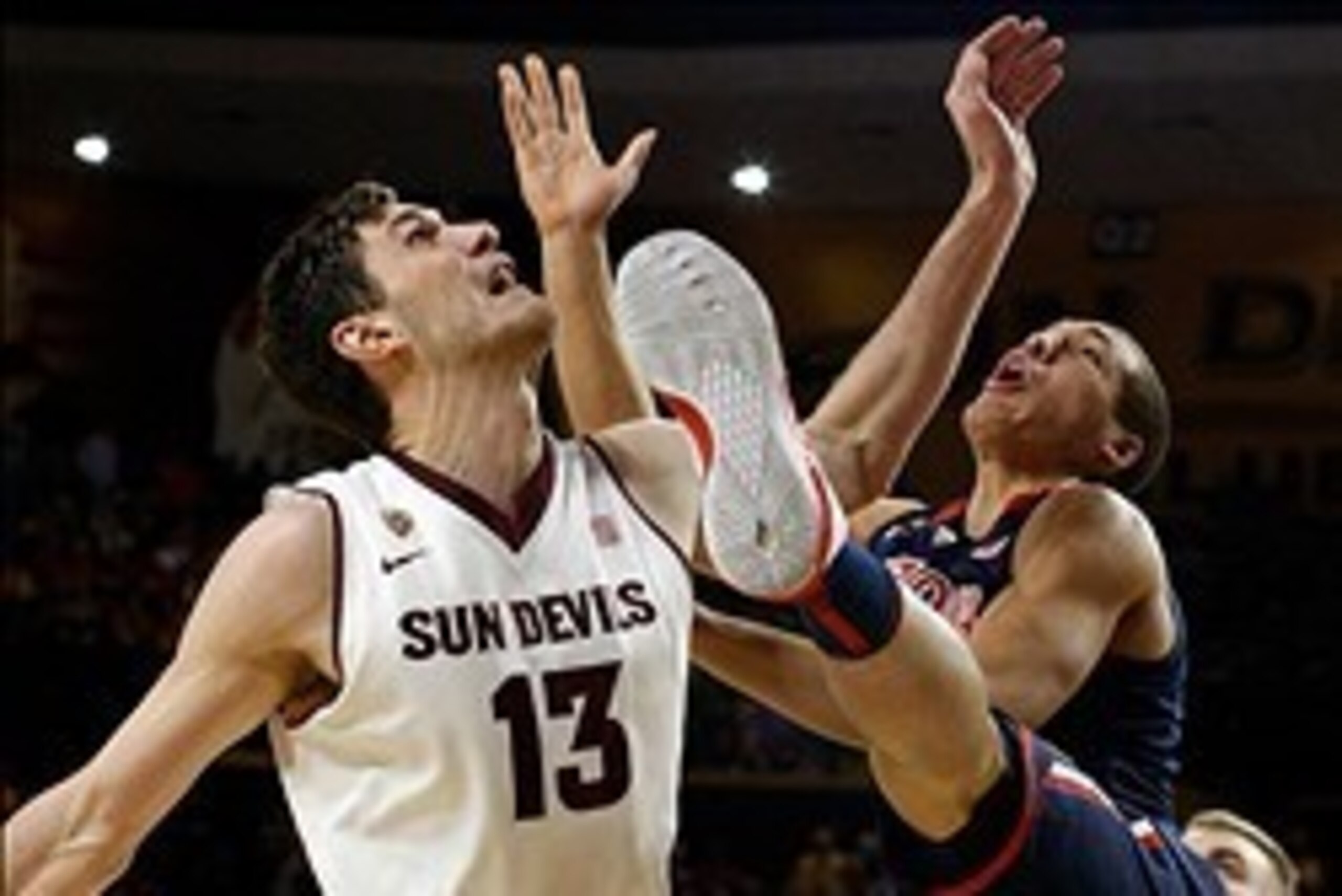 Feb 14, 2014; Tempe, AZ, USA; Arizona State Sun Devils center Jordan Bachynski (13) and Arizona Wildcats forward Aaron Gordon (11) battle for the ball during the first half at Wells Fargo Arena. Mandatory Credit: Rick Scuteri-USA TODAY Sports