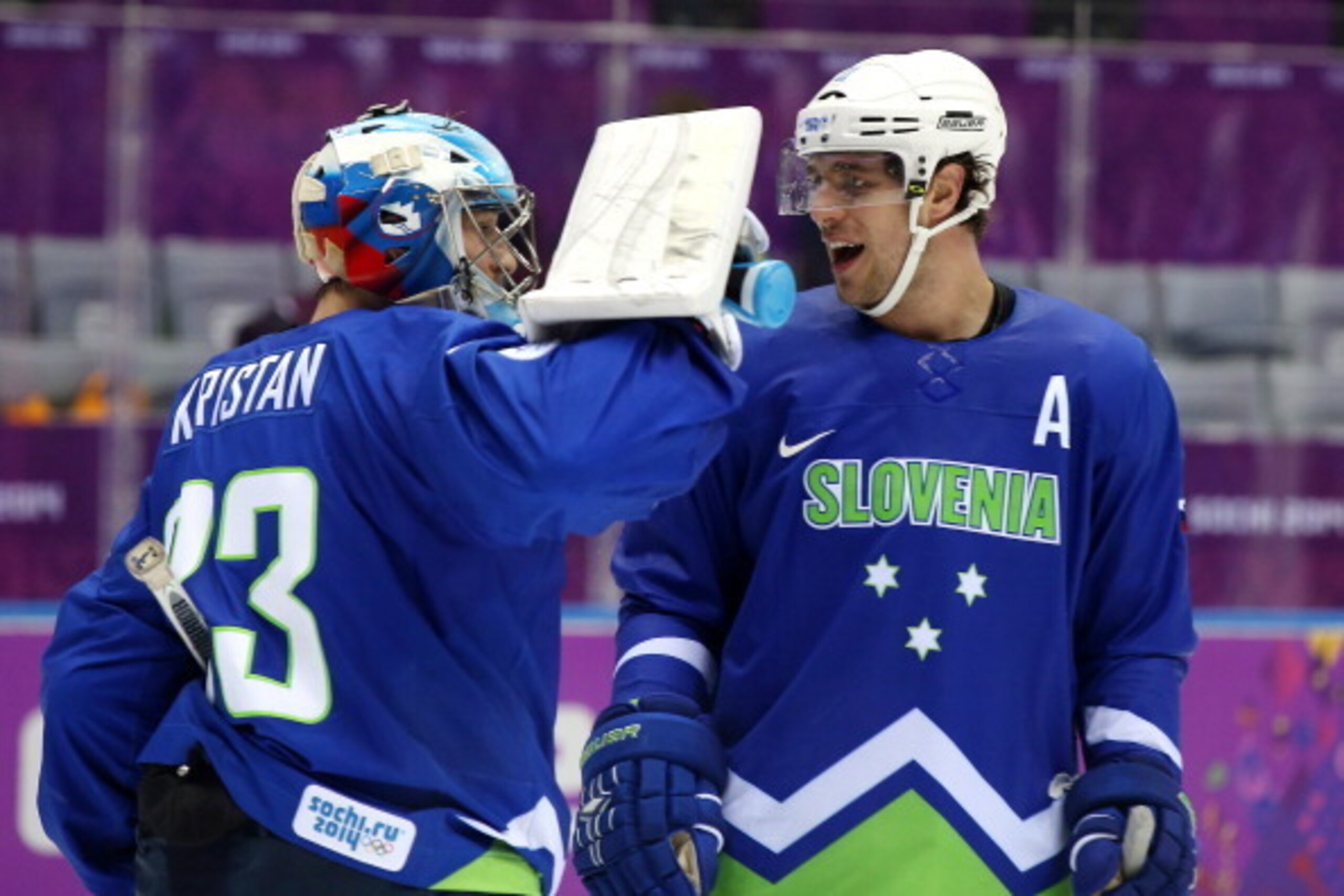SOCHI, RUSSIA - FEBRUARY 15:  Robert Kristan #33 of Slovenia celebrates with Anze Kopitar #11 after defeating Slovakia 3-1 during the Men's Ice Hockey Preliminary Round Group A game on day eight of the Sochi 2014 Winter Olympics at Bolshoy Ice Dome on Feb