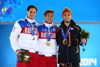 SOCHI, RUSSIA - FEBRUARY 15:  (L-R) Silver medalist Vladimir Grigorev of Russia, gold medalist Victor An of Russia and bronze medalist Sjinkie Knegt of the Netherlands on the podium during the medal ceremony for Short Track Speed Skating MenÂfs 1000m on d
