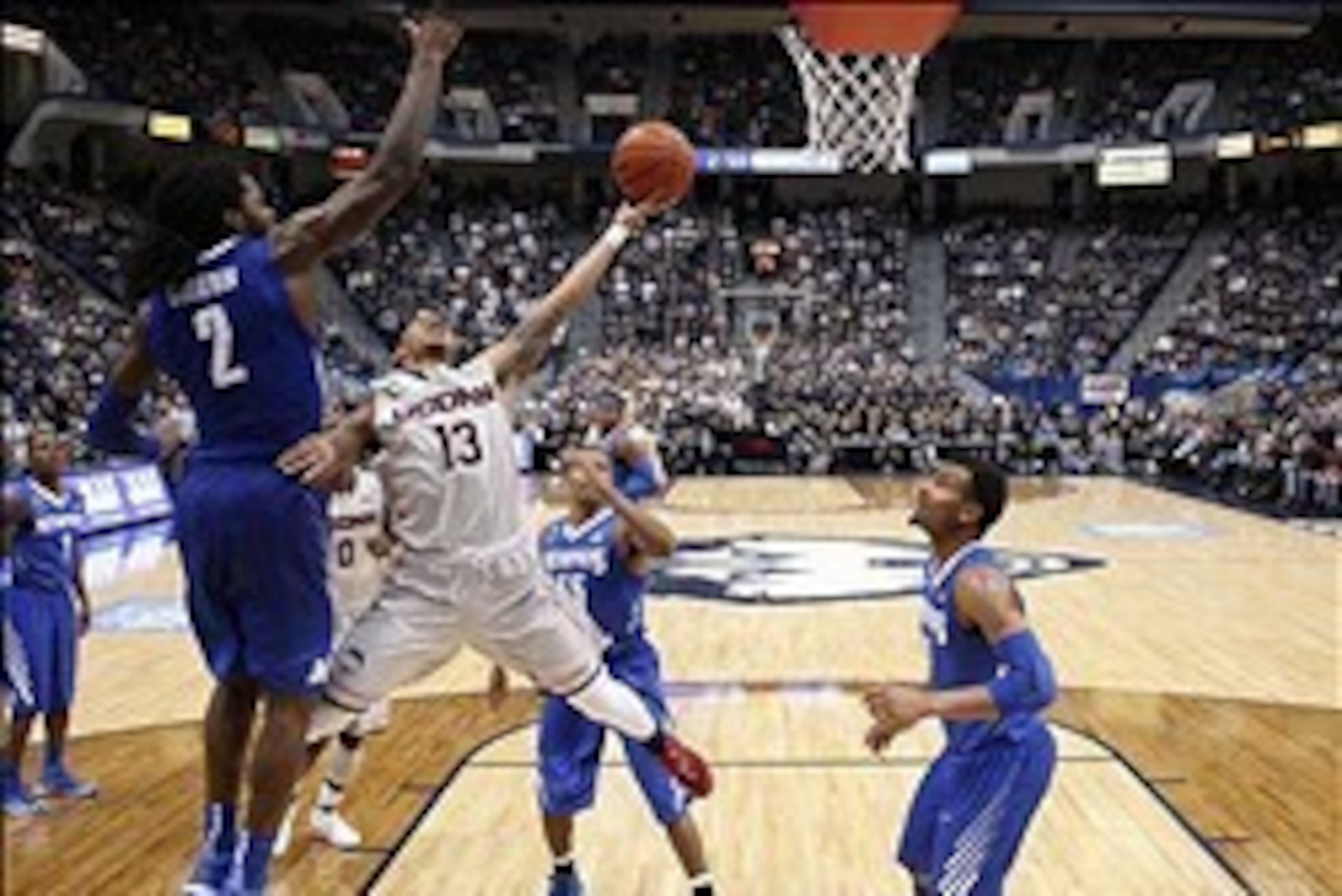 Feb 15, 2014; Hartford, CT, USA; Connecticut Huskies guard Shabazz Napier (13) drives to the basket against Memphis Tigers forward Shaq Goodwin (2) in the second half at XL Center. UConn defeated the Memphis Tigers 86-81. Mandatory Credit: David Butler II