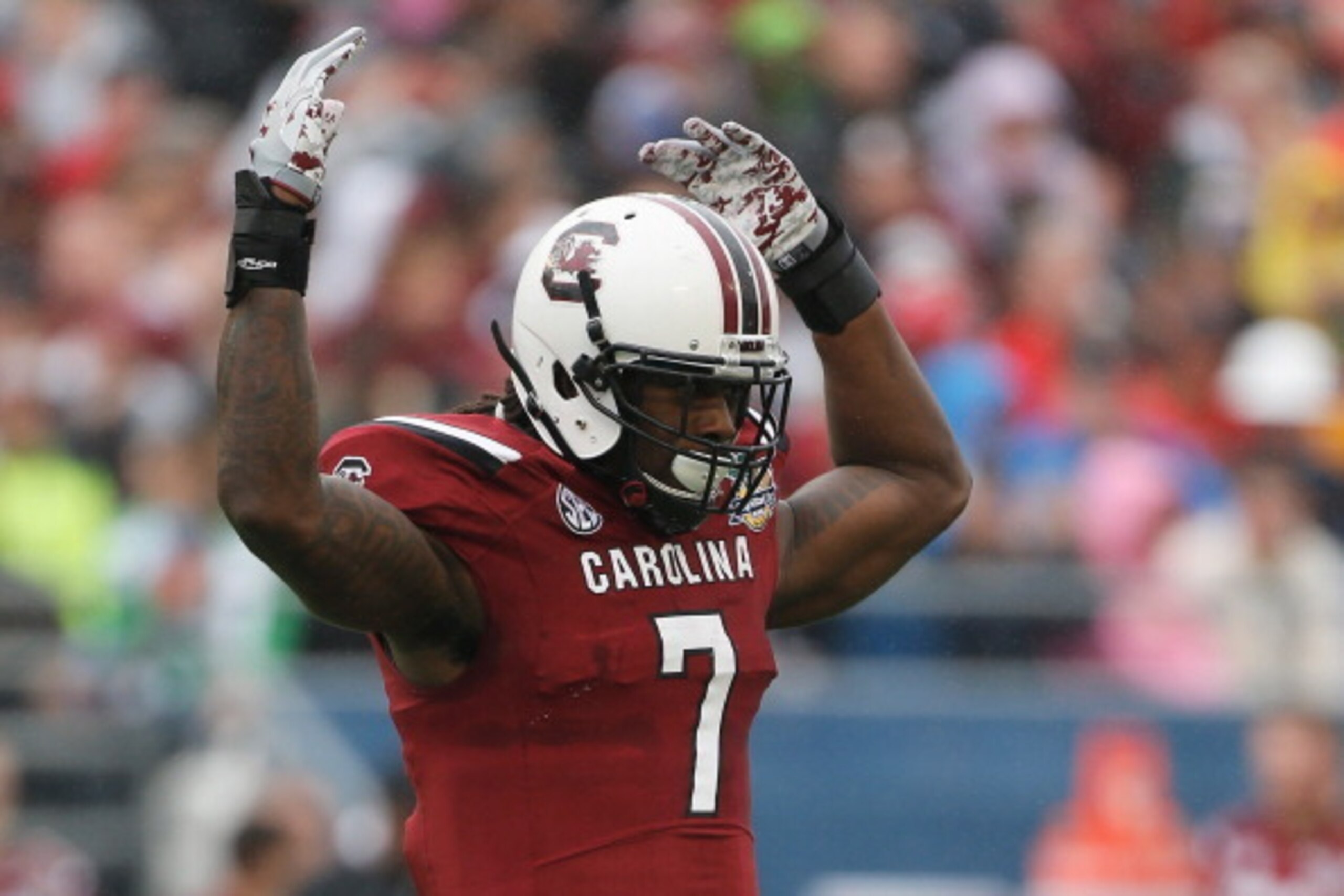 ORLANDO, FL - JANUARY 01:  Jadeveon Clowney #7 of the South Carolina Gamecocks gets the crowd excited in the first half of their game against the Wisconsin Badgers at the Capital One Bowl on January 1, 2014 in Orlando, Florida.  (Photo by Scott Halleran/G