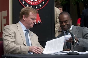 NFL commissioner Roger Goodell and NFLPA executive director DeMaurice Smith sign the current NFL CBA.
