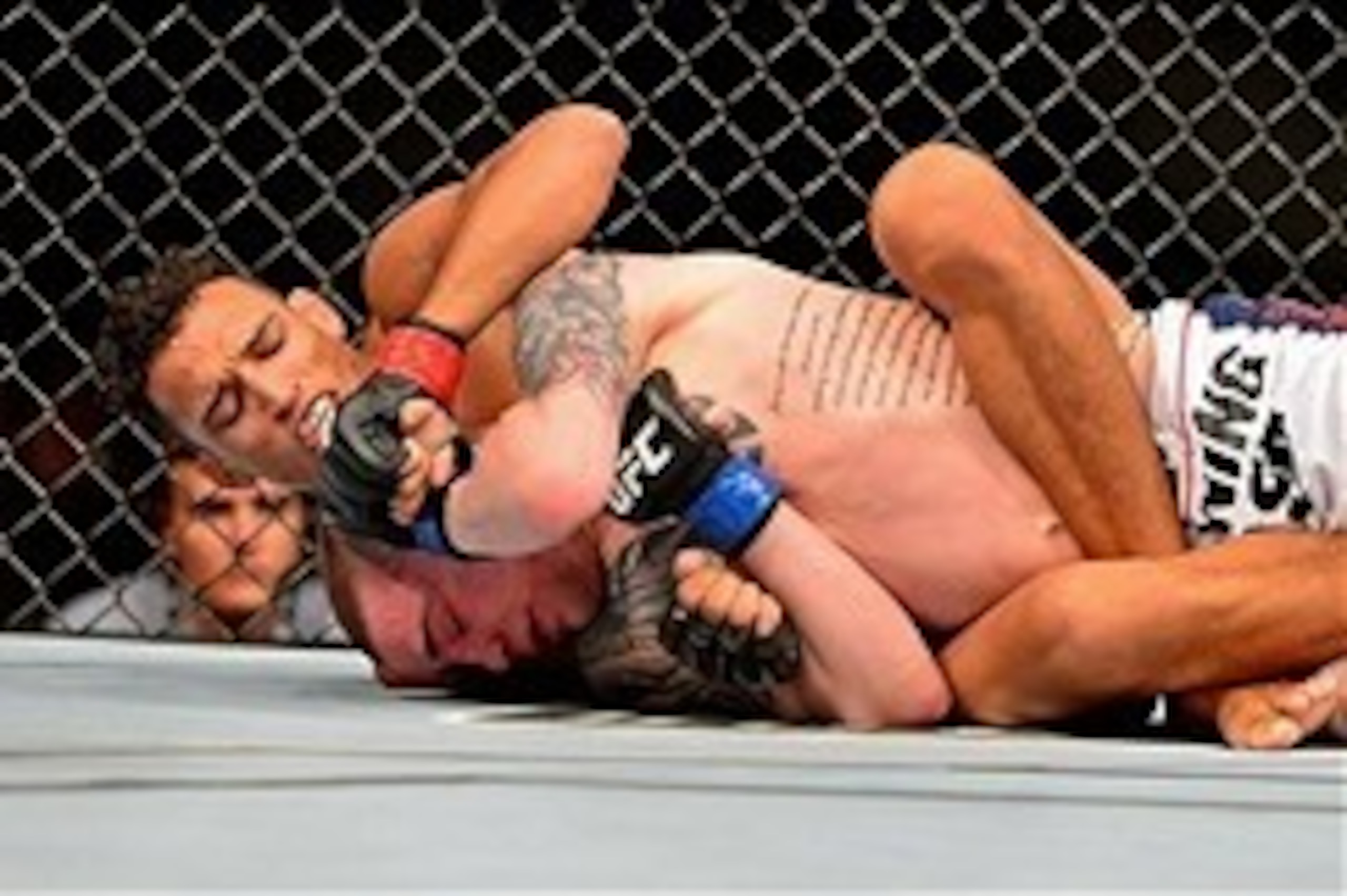 Feb 15, 2014; Jaragua do Sul, SC, Brazil; Charles Oliveira (red gloves) fights Andy Ogle (blue gloves) during UFC Fight Night Machida vs Mousasi at Arena Jaragua. Mandatory Credit: Jason Silva-USA TODAY Sports