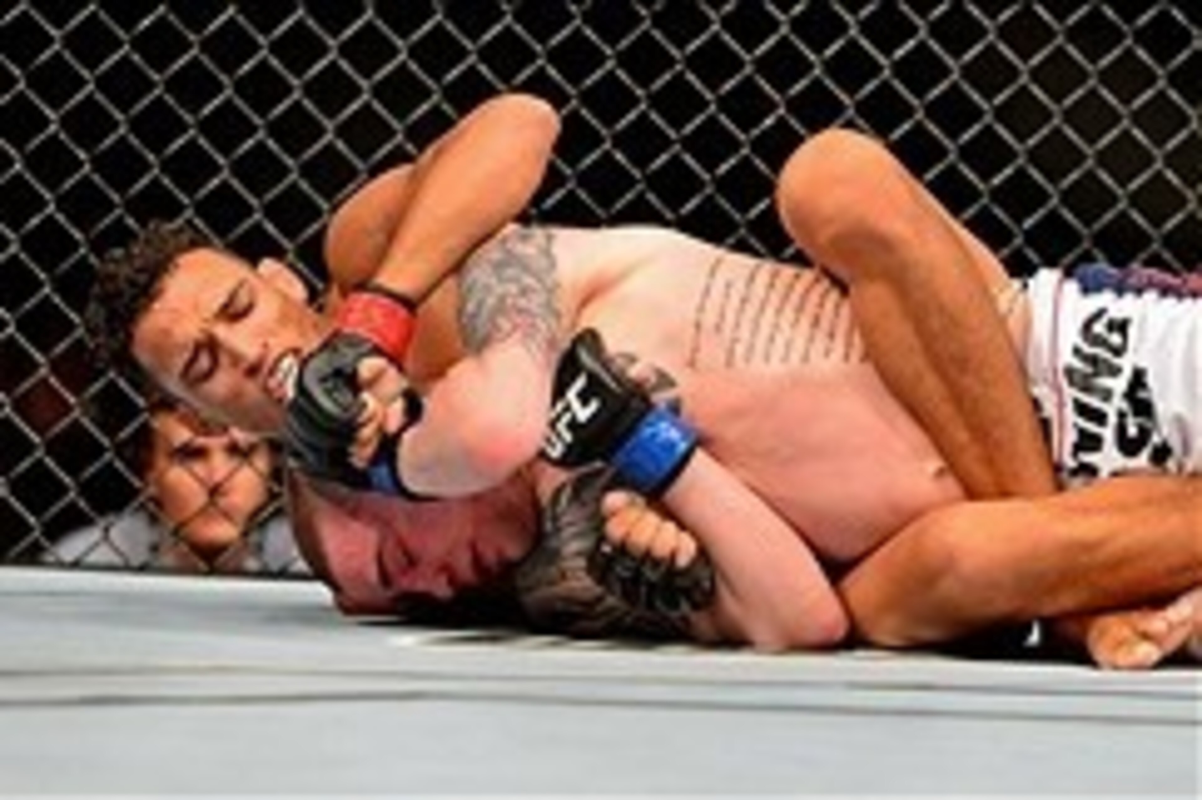 Feb 15, 2014; Jaragua do Sul, SC, Brazil; Charles Oliveira (red gloves) fights Andy Ogle (blue gloves) during UFC Fight Night Machida vs Mousasi at Arena Jaragua. Mandatory Credit: Jason Silva-USA TODAY Sports
