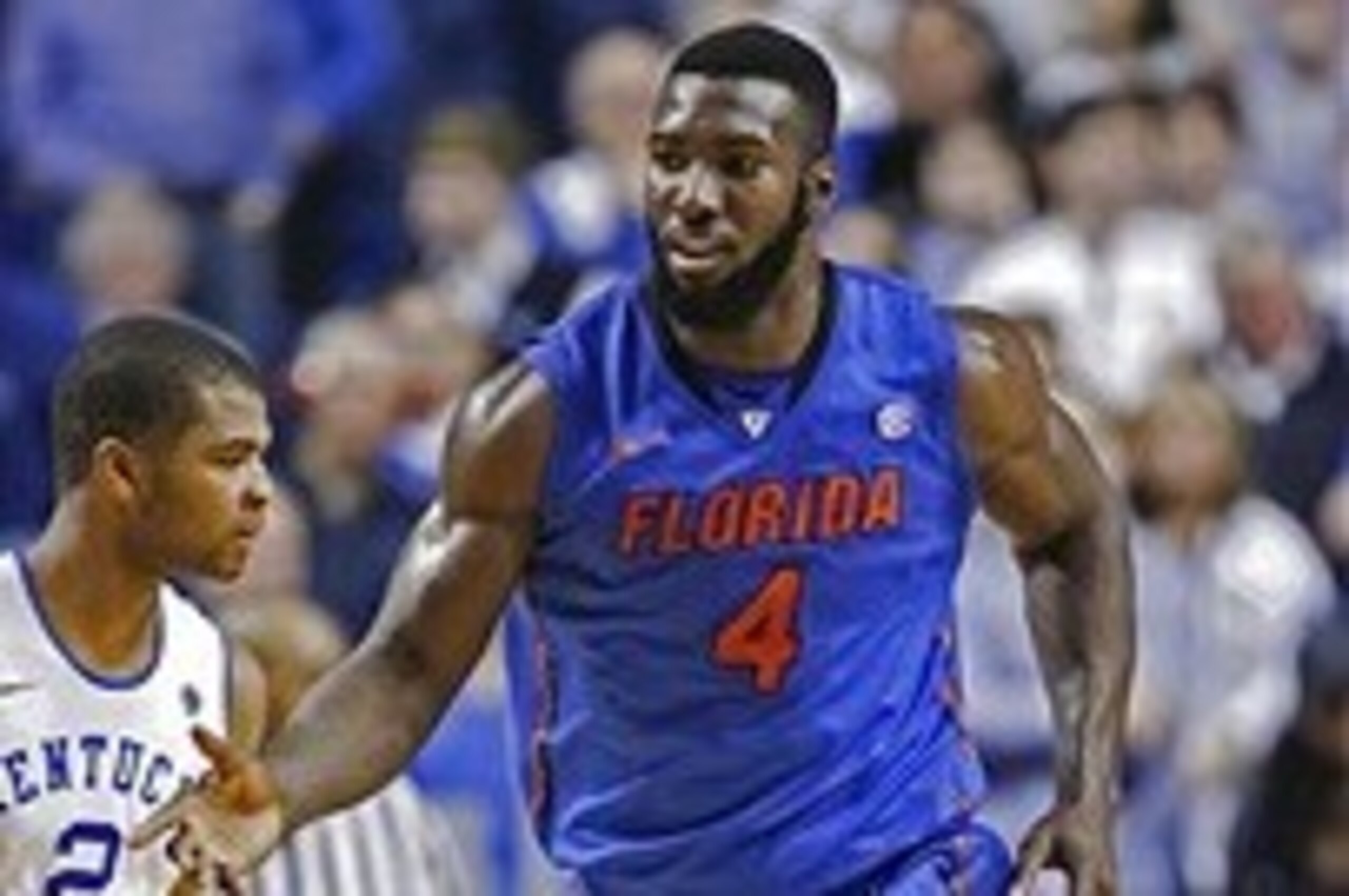 Feb 15, 2014; Lexington, KY, USA; Florida Gators center Patric Young (4) celebrates against Kentucky Wildcats guard Aaron Harrison (2) at Rupp Arena. Florida defeated Kentucky 69-59. Mandatory Credit: Mark Zerof-USA TODAY Sports