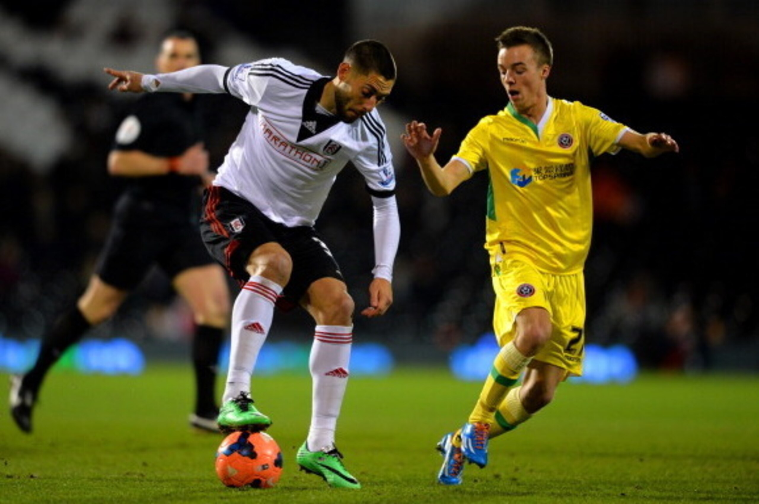 LONDON, ENGLAND - FEBRUARY 04:  Clint Dempsey of Fulham ais marshalled by Stefan Scougall of Sheffield United during the FA Cup Fourth Round Replay match between Fulham and Sheffield United at Craven Cottage on February 4, 2014 in London, England.  (Photo